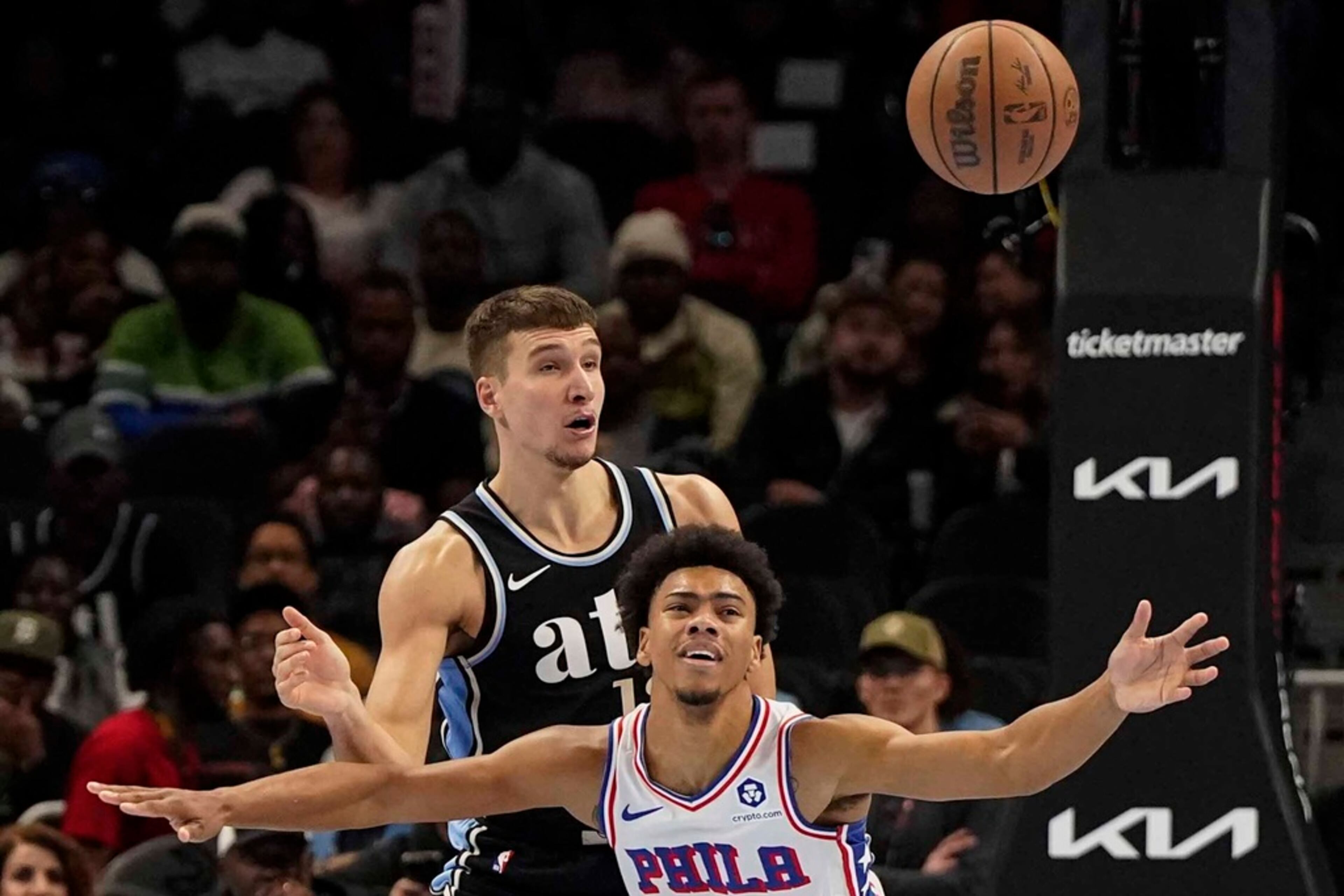 Philadelphia 76ers guard Jaden Springer (11) loses the ball against Atlanta Hawks guard Bogdan Bogdanovic (13) during the first half of an In-Season Tournament NBA basketball game, Friday, Nov. 17, 2023, in Atlanta. (AP Photo/Mike Stewart)