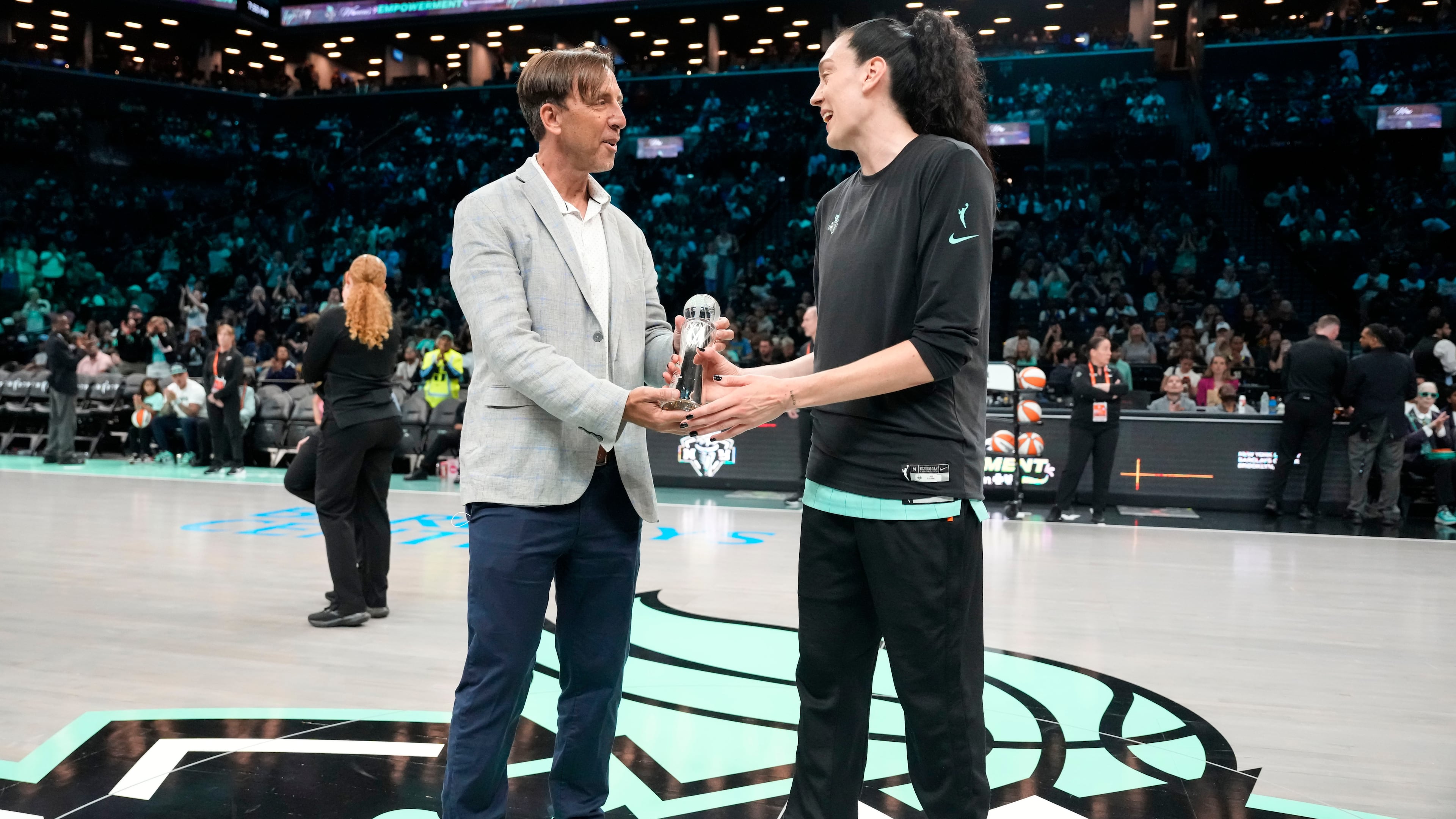 The Associated Press' Global Sports Editor Josh Hoffner presents the Greatest Player award to New York Liberty forward Breanna Stewart ahead of a WNBA basketball game against the Dallas Wings, Tuesday, July 7, 2026, in New York. (AP Photo/Yuki Iwamura)