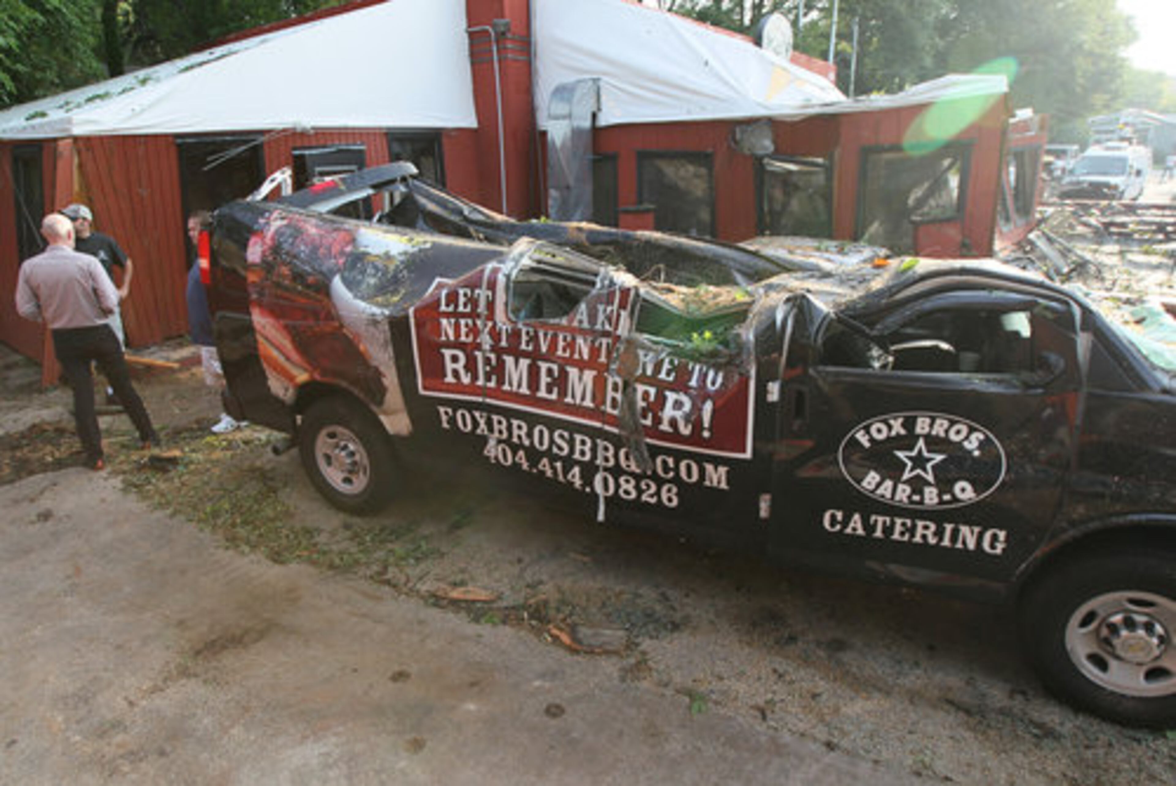 The tree crushed the restaurant and one of the restaurant's catering vehicles.