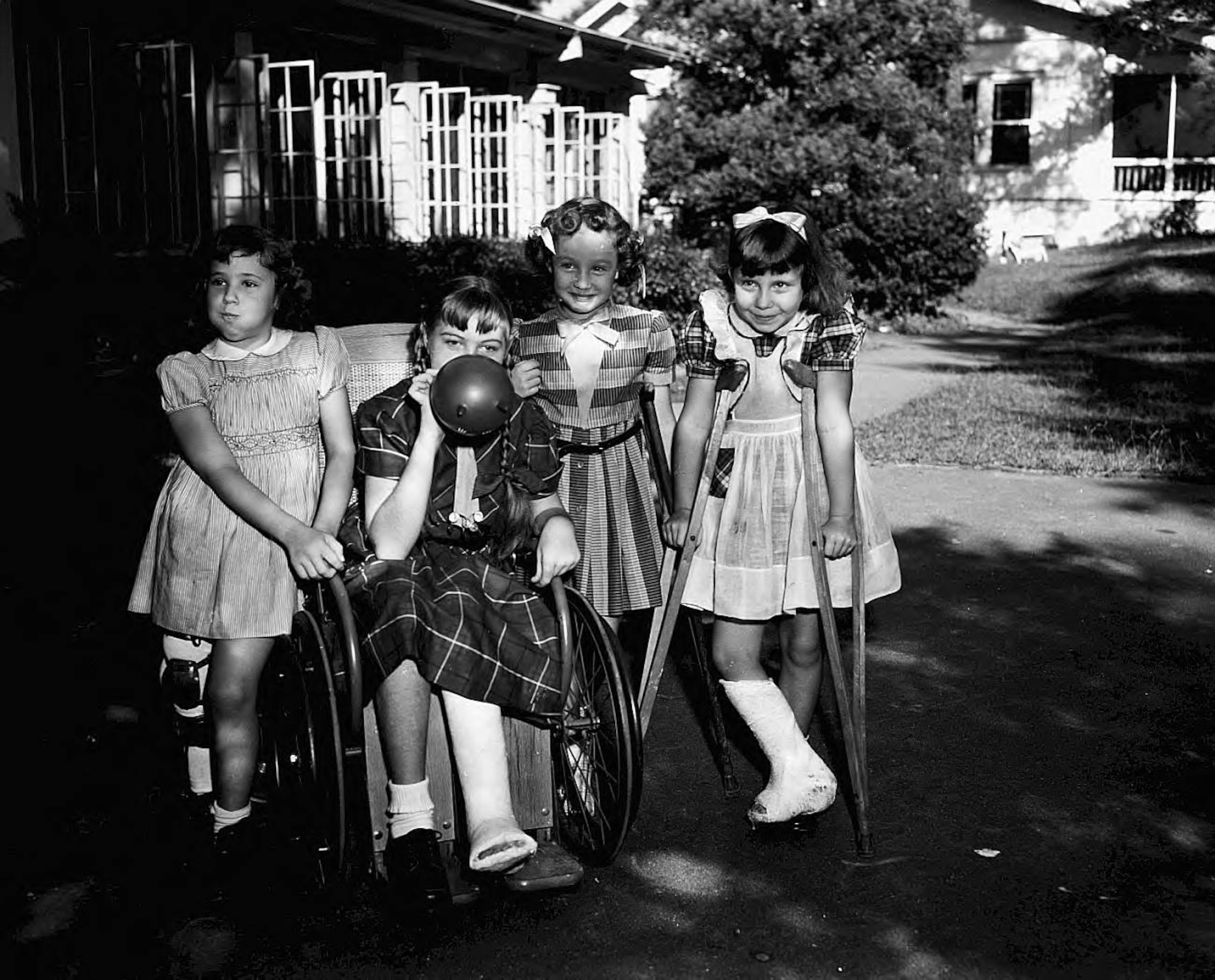 Four young ladies on the lawn in front of the Scottish Rite Hospital for Crippled Children in 1953. LBCB095-009b, Lane Brothers Commercial Photographers Photographic Collection, 1920-1976. Photographic Collection, Special Collections and Archives, Georgia State University Library.