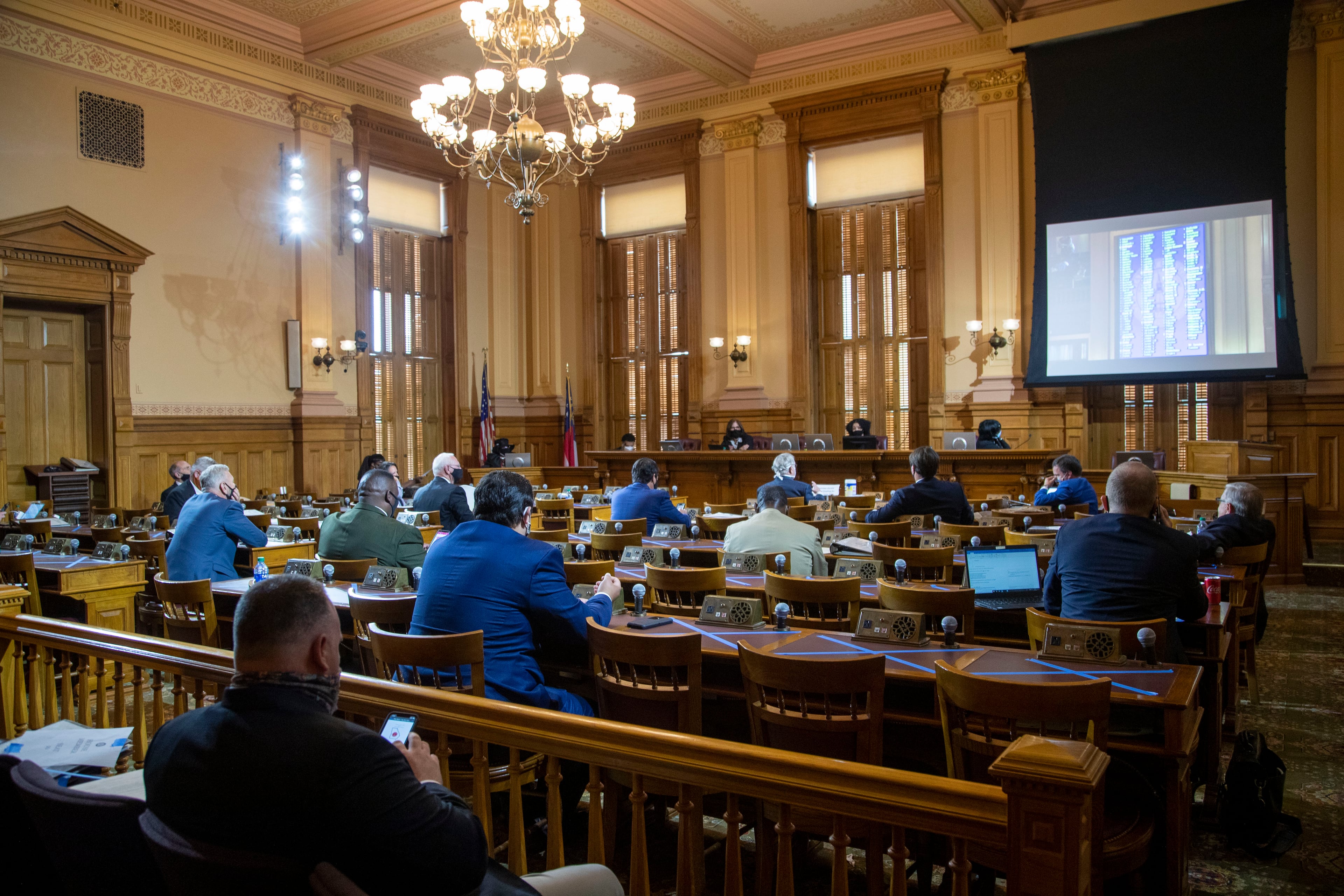 06/15/2020 - Atlanta , Georgia - Members of the Georgia House of Representatives watch their peers work out of the House chamber as they live stream the session from the Senate Committee Room during the 30th day of the legislative session at the Georgia State Capitol building, Monday, June 15, 2020. Due to COVID-19 restrictions, members of the house were seated on the floor of the house, the gallery of the house and in the Senate Committee Room. (ALYSSA POINTER / ALYSSA.POINTER@AJC.COM)