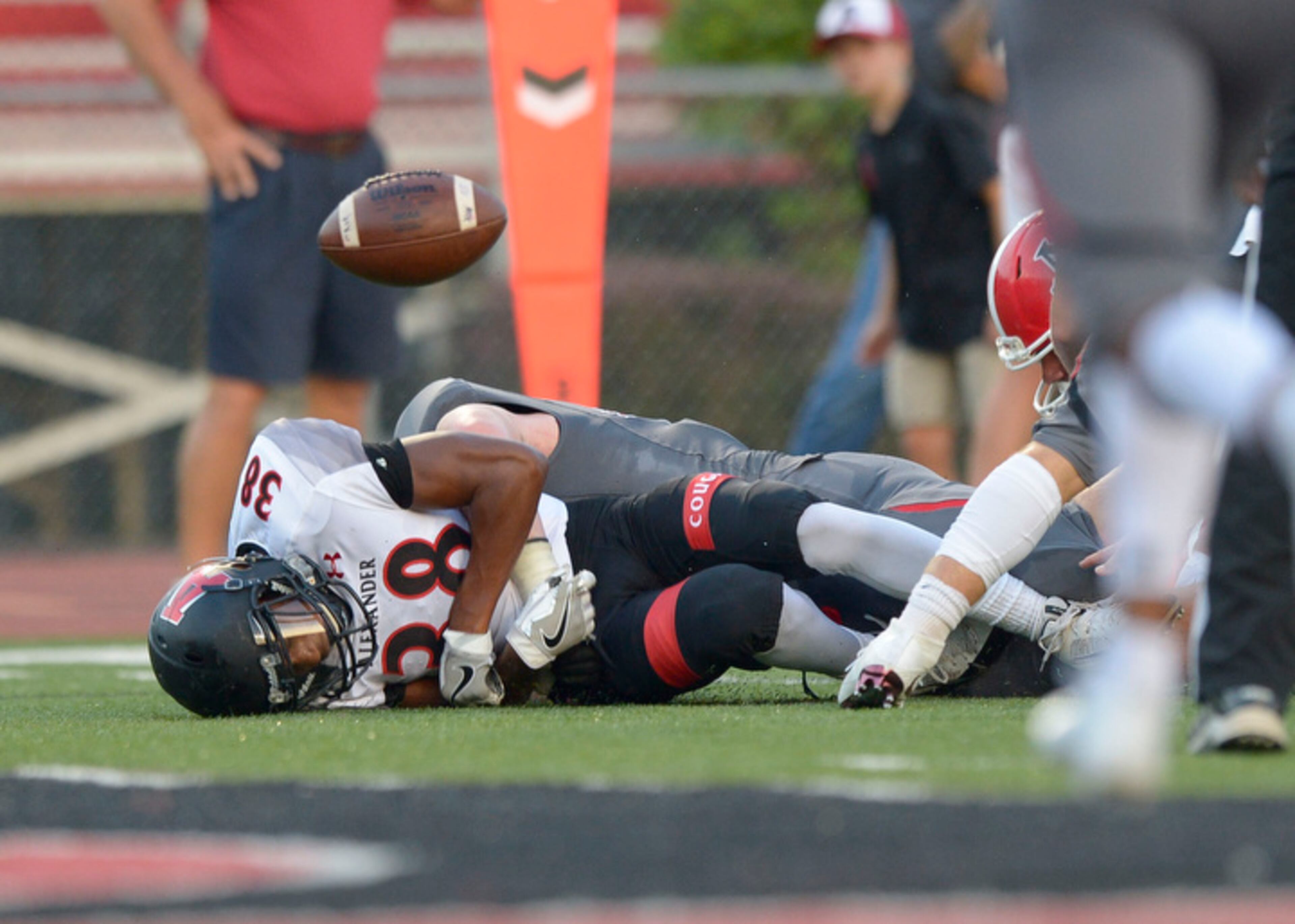 Allatoona sophomore CB Amiri Austin (38) fumbles the ball after being tackled near the Alexander end zone in the first half of his game at Allatoona Friday, August 25, 2017.