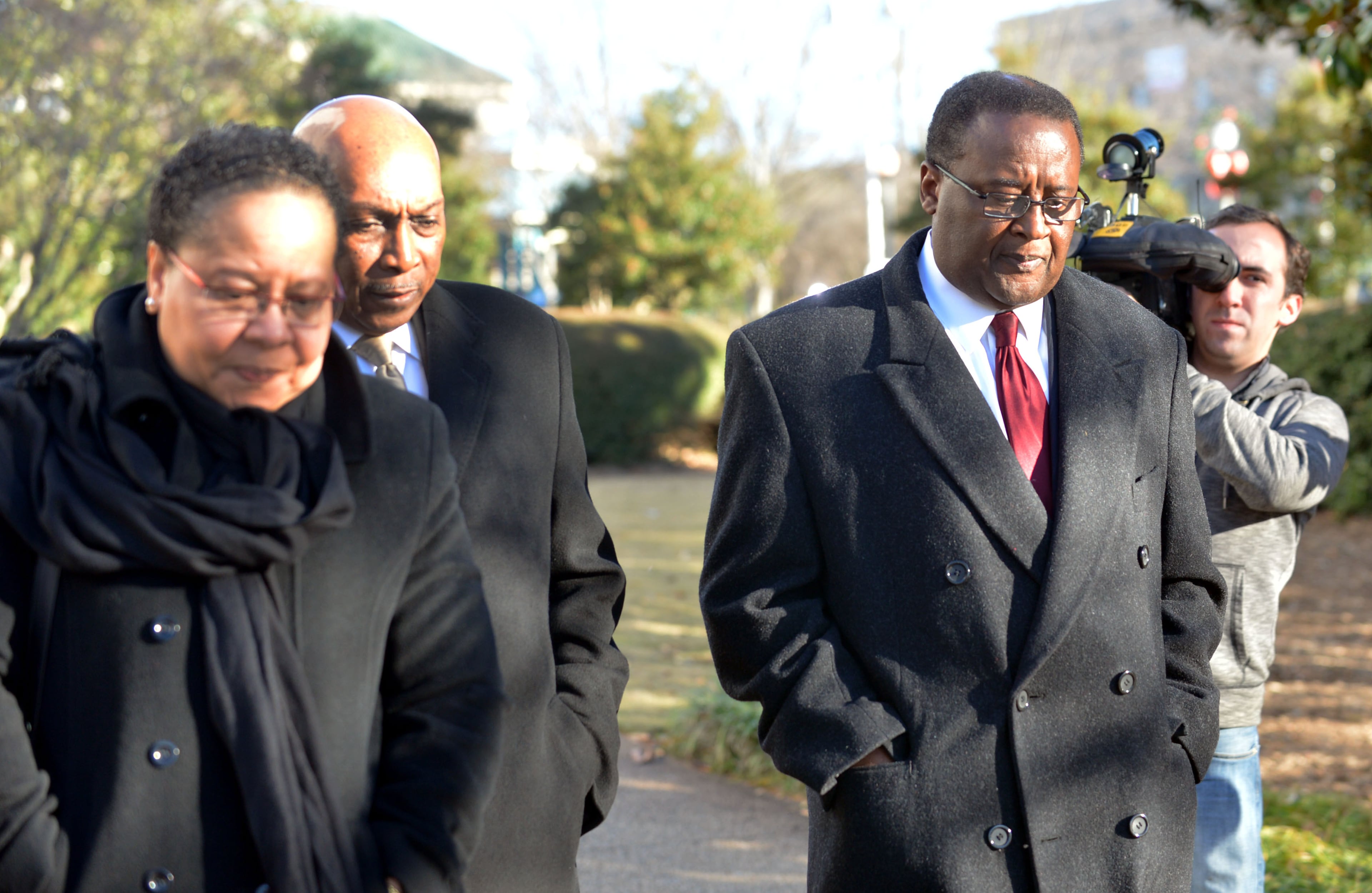 Crawford Lewis (right) walks with his wife Sandra, and defense co-counsel Bernard Taylor as he leaves the courthouse following the hearing. Judge Cynthia Becker heard from attorneys for former DeKalb School Superintendent Crawford Lewis in court Tuesday December 17, 2013. He is requesting that he be allowed to withdraw his guilty plea to a misdemeanor if she will not honor prosecutors' recommendation that he be sentenced to probation; no jail time. Lewis' attorney had asked for an "emergency hearing" the day after he was sentenced to 12 months in the DeKalb County Jail and taken out of the courtroom in handcuffs to begin serving his time. Becker set the hearing for eight days after he was sentenced. KENT D. JOHNSON / KDJOHNSON@AJC.COM
