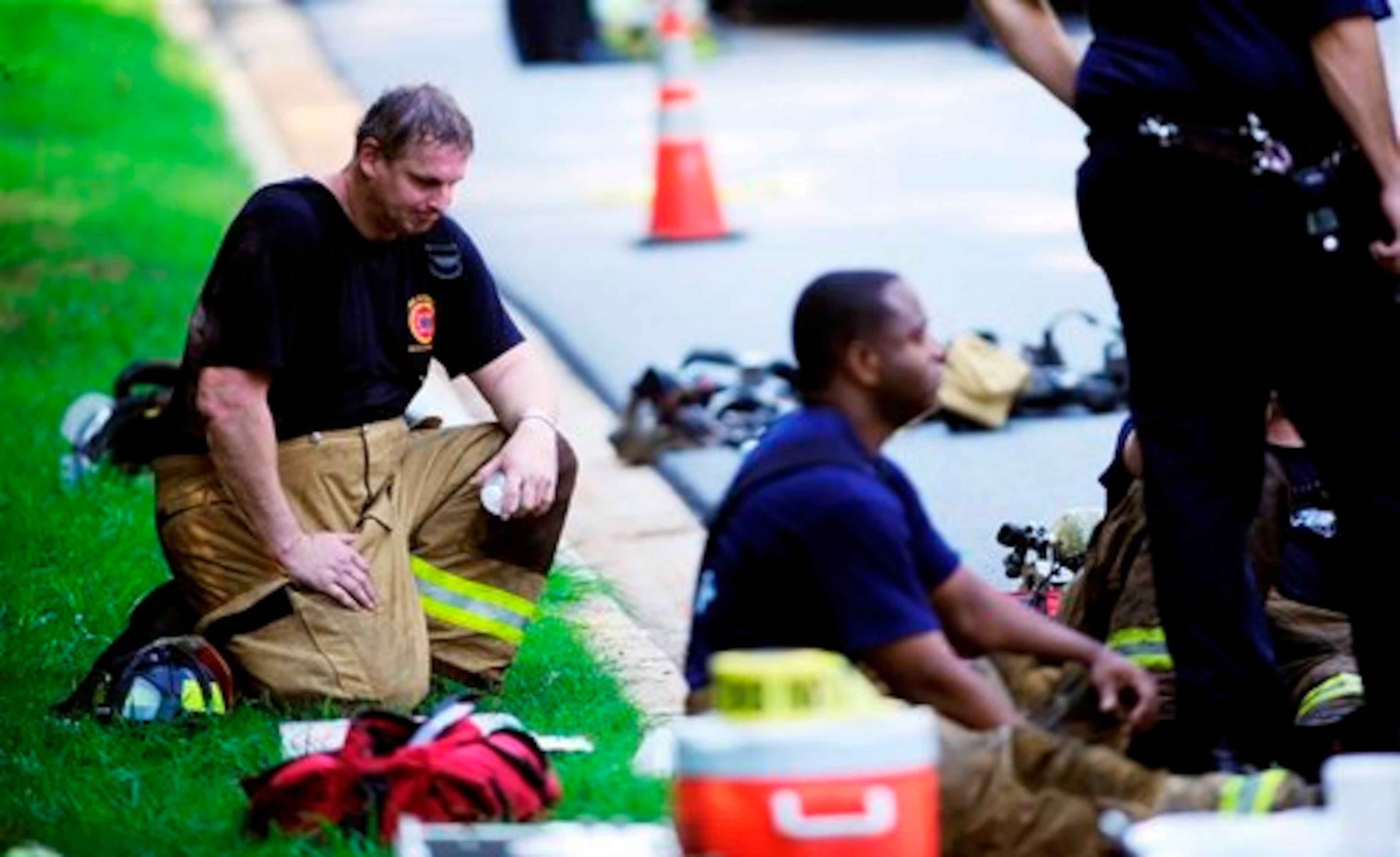DeKalb county firefighter Roger Cole takes a break from fighting the fire. Four firefighters suffered heat exhaustion battling the blaze.