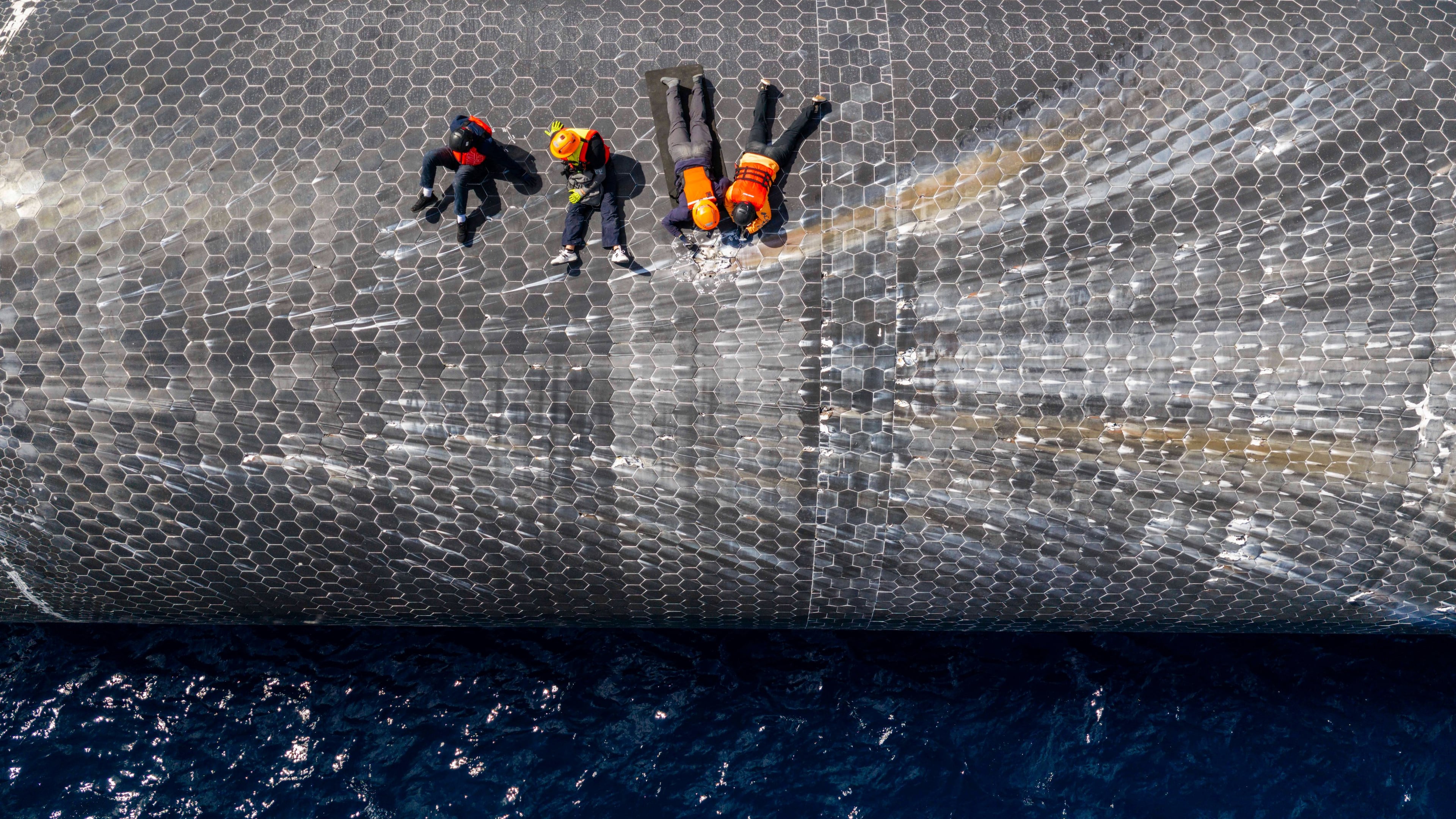 This image provided by SpaceX on Aug. 27, 2026, shows engineers inspecting Starship off the coast of Christmas Island in the Indian Ocean, following its launch on a test flight back in July. (SpaceX via AP)