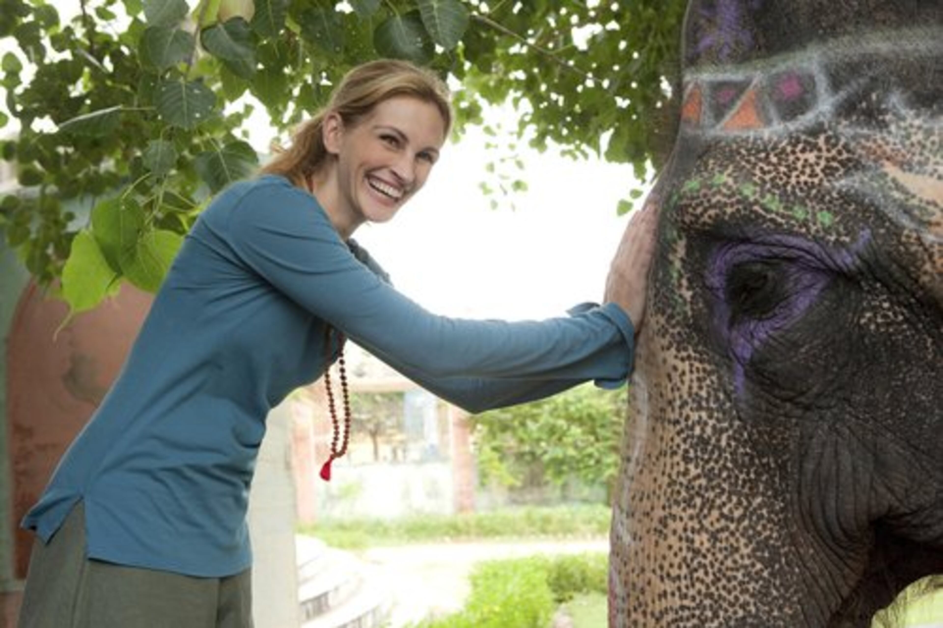 Julia Roberts poses with an elephant while filming a scene for the film "Eat, Pray, Love." The travel industry is courting fans of the book, 'Eat, Pray, Love,' Elizabeth Gilbert's best-selling memoir about the year Gilbert spent living in Italy, India and Indonesia on the rebound from a divorce and failed romance.