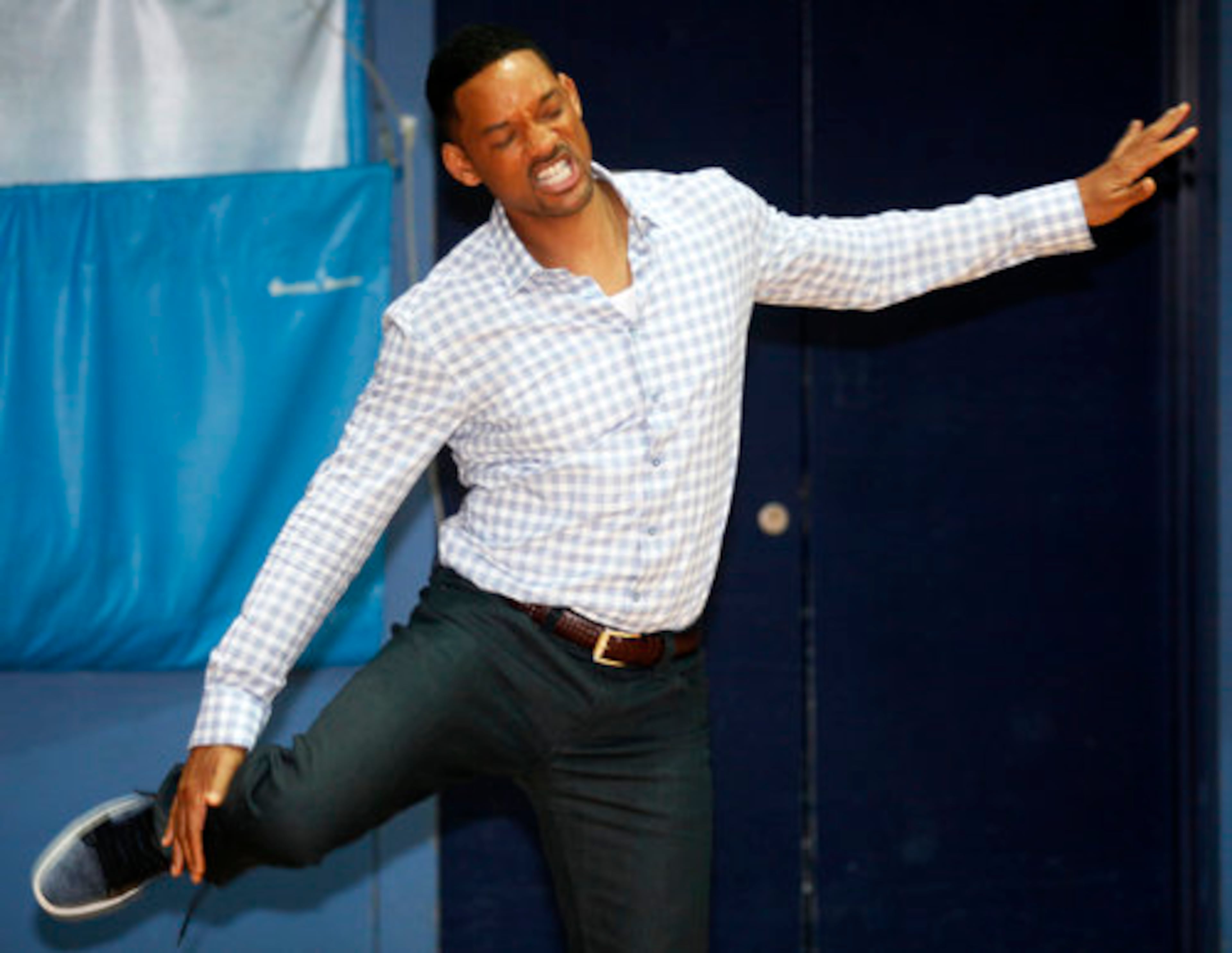 Actor Will Smith, in London to promote his new movie "Men In Black 3," stretches before taking on Olympic hopefuls at Ethos Sports Centre in anticipation of the London Games this summer.