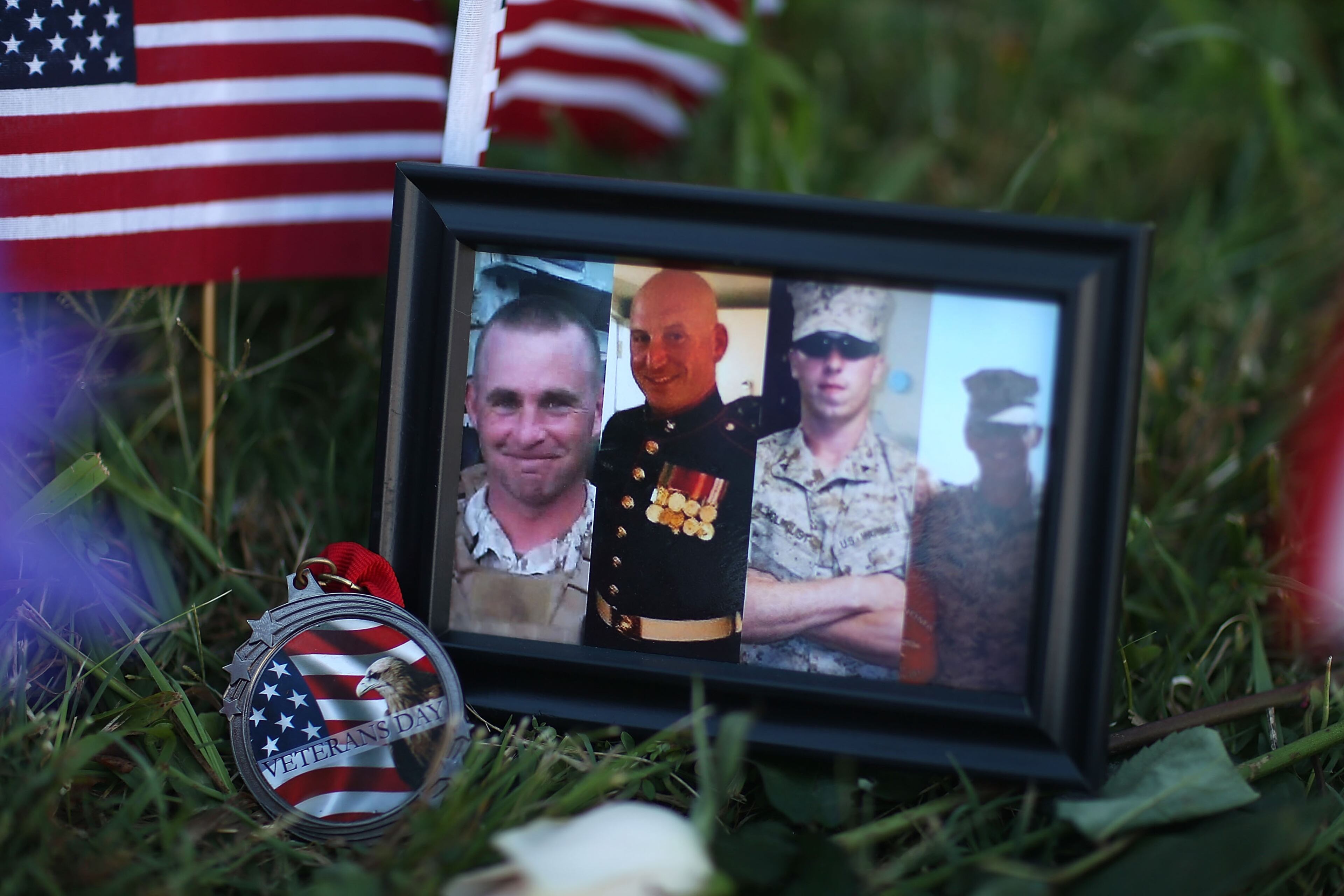 CHATTANOOGA, TN - JULY 18: A photograph of the victims is seen among the memorial setup in front of the Armed Forces Career Center/National Guard Recruitment Office on July 18, 2015 in Chattanooga, Tennessee. According to reports, Mohammod Youssuf Abdulazeez, 24, opened fire on the military recruiting station on July 16th at the strip mall and then drove to an operational support center operated by the U.S. Navy and killed four United States Marines there, more than seven miles away, (Photo by Joe Raedle/Getty Images)