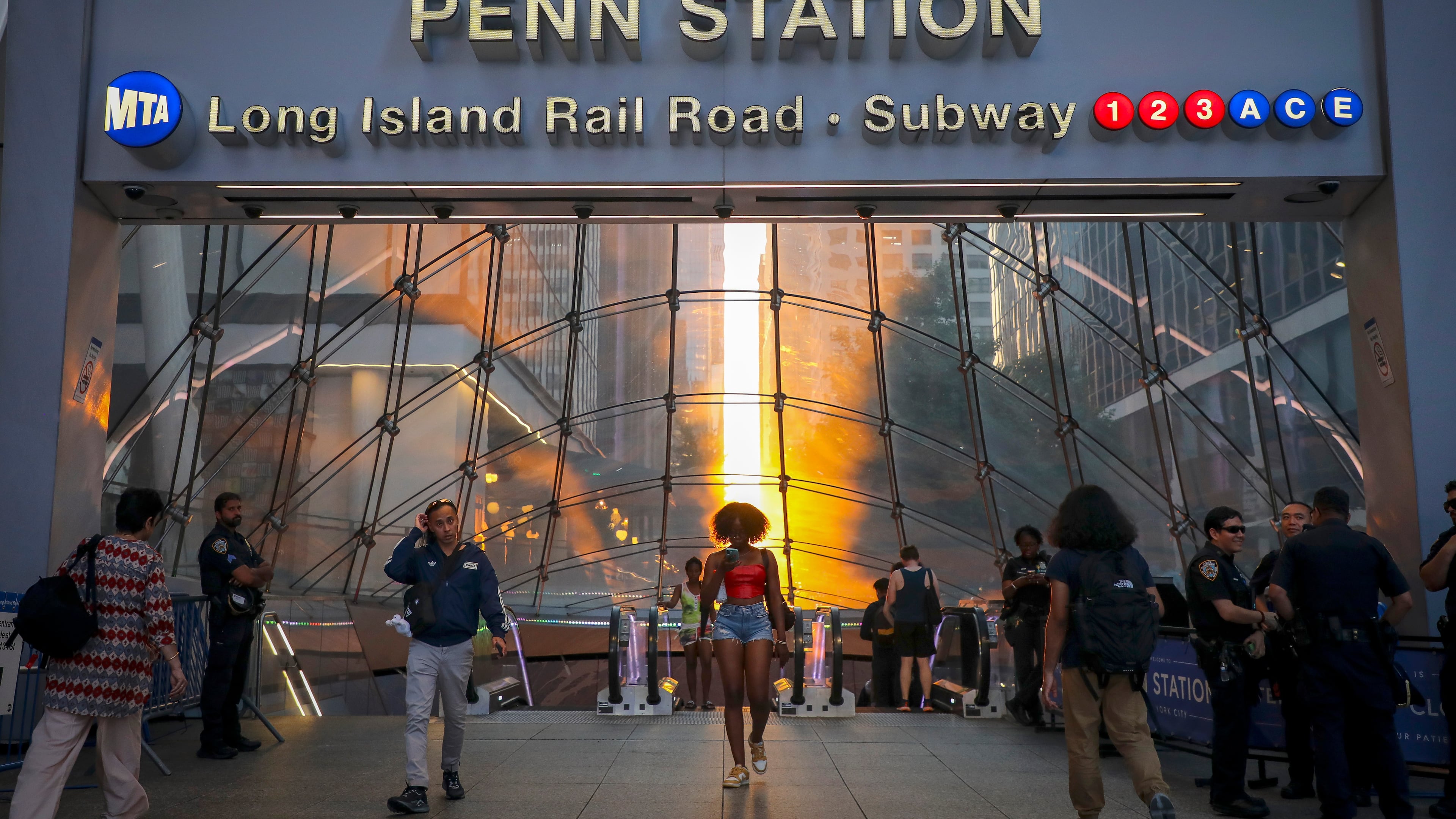 FILE - Commuters pass Penn Station and Madison Square Garden, July 2, 2026, in New York. (Photo by Andy Kropa/Invision/AP, File)