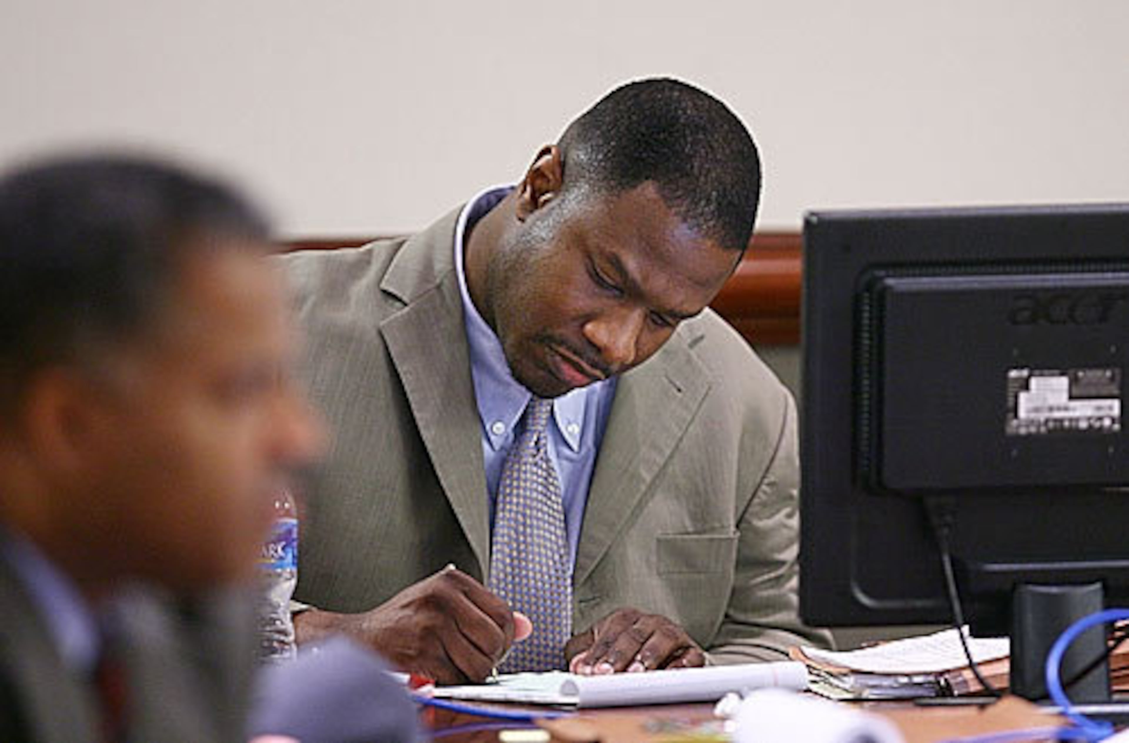 Brian Nichols writes on a notepad while listening to testimony Friday in his murder case.