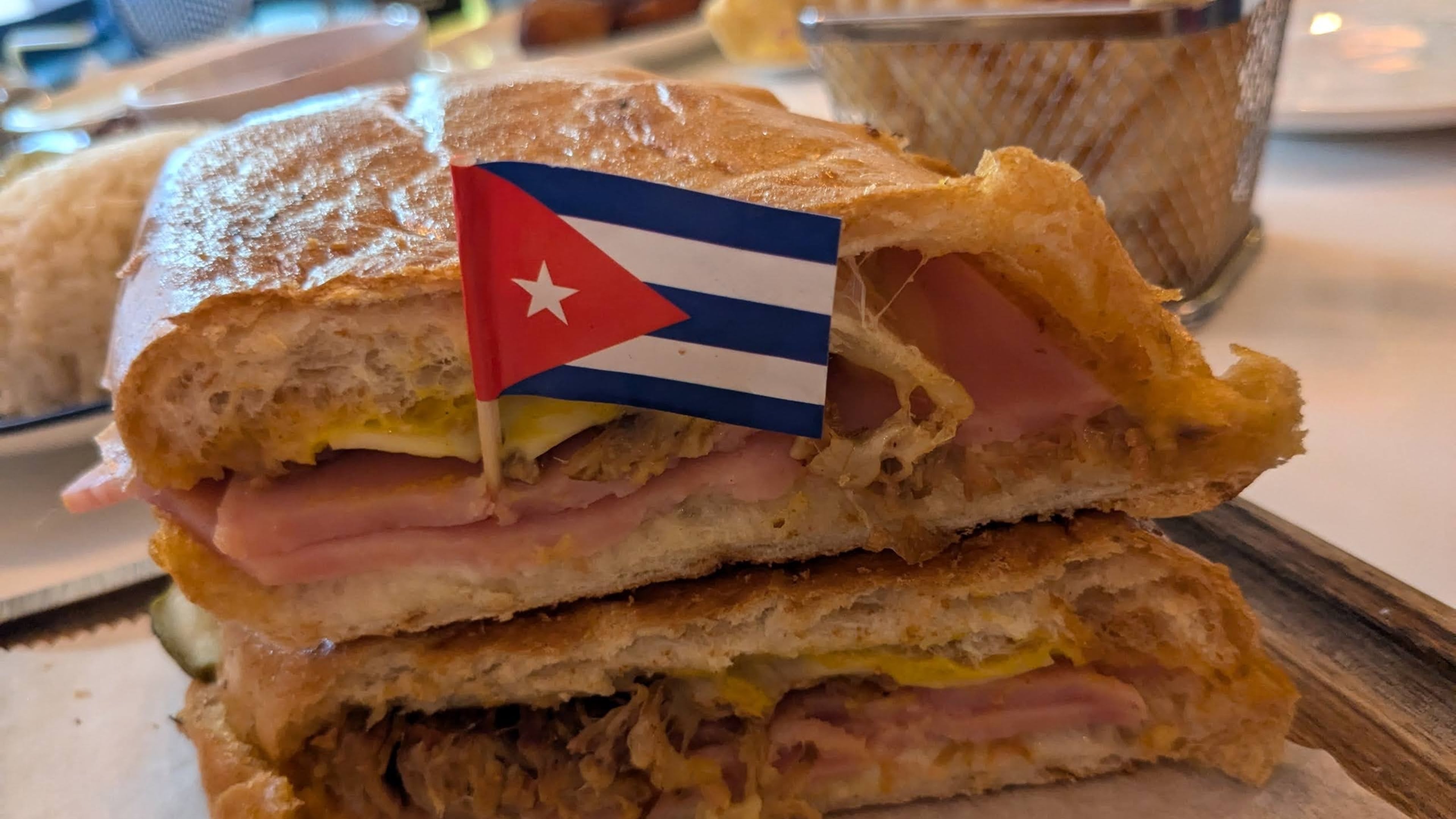 The pressed Cuban sandwich from Azucar Cuban Cuisine is a classic combination of slow-roasted pork, ham, Swiss cheese, dill pickles, mayonnaise and mustard. (Paula Pontes for The Atlanta Journal-Constitution)