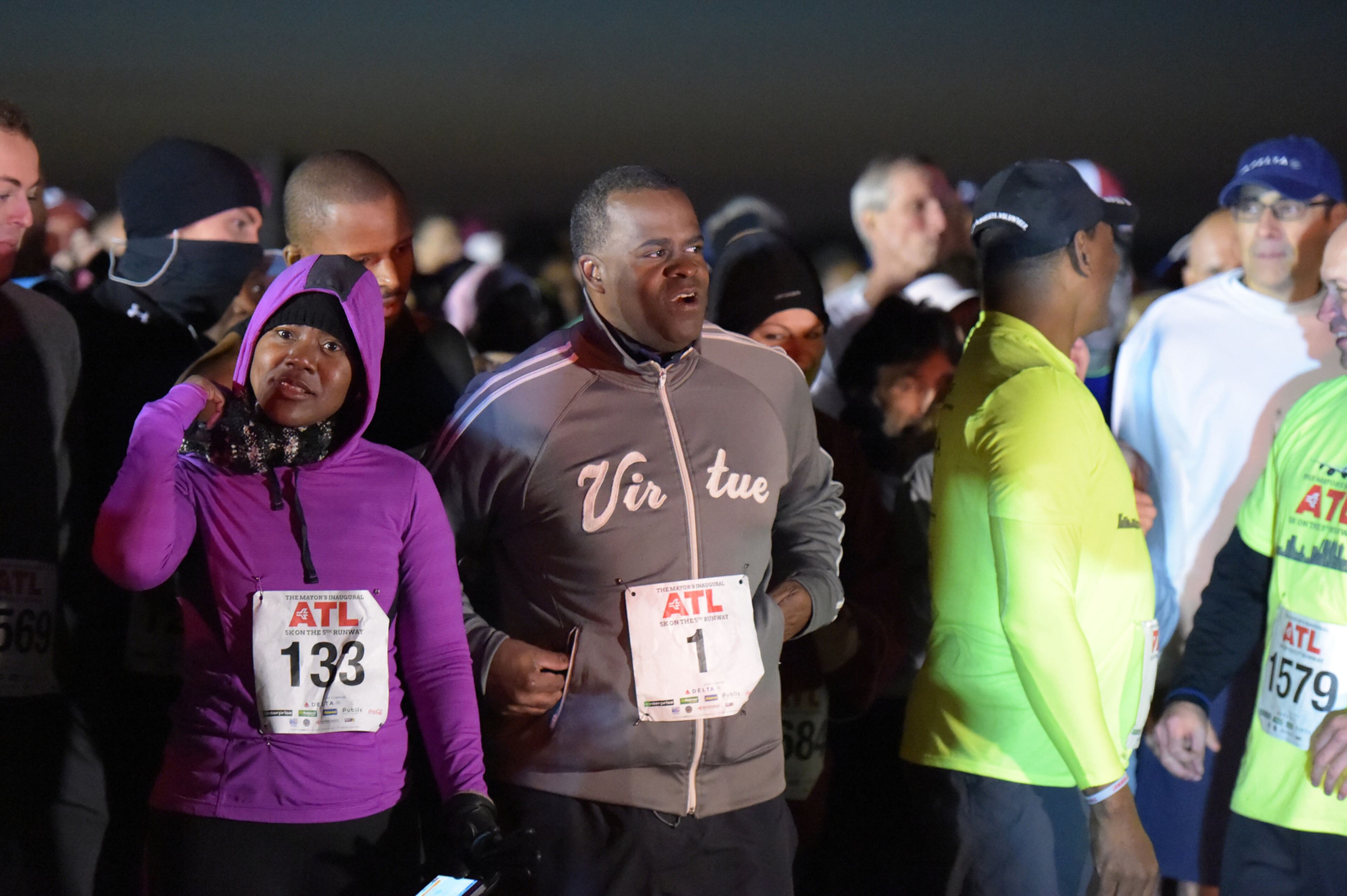 OCTOBER 17, 2015 ATLANTA Candace Byrd, Chief of Staff for Mayor Reed (left), Mayor Kasim Reed (center) and United Way President Milton Little joined more than 2,000 runners at the Mayor’s Inaugural 5K on the 5th Runway at the world’s busiest airport Saturday, October 17, 2015. Airport officials shut down the 5th runway (Runway 10/28) until 8:15 am so runners and walkers could exit the course. All proceeds from the event will benefit United Way of Greater Atlanta. Major sponsors of The Mayor’s Inaugural 5K on the 5th Runway include Delta Air Lines, The Coca-Cola Company, Enterprise Rental Car, Georgia International Convention Center, MARTA, and Publix. Over $123,000 was raised, said airport spokesman Reese McCranie. The race's overall winner was Andrew Murfee, 15, a Woodward Academy student. KENT D. JOHNSON/KDJOHNSON@AJC.COM
