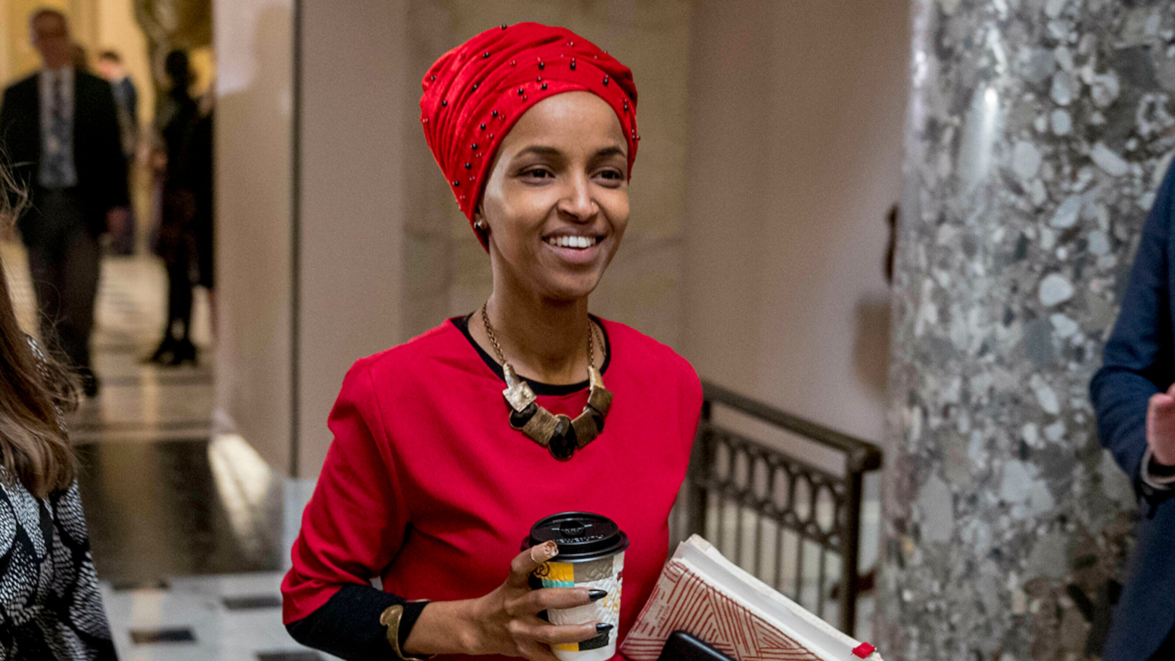 In this Jan. 16, 2019 file photo, Rep. Ilhan Omar, D-Minn., center, walks through the halls of the Capitol Building in Washington. (AP Photo/Andrew Harnik)