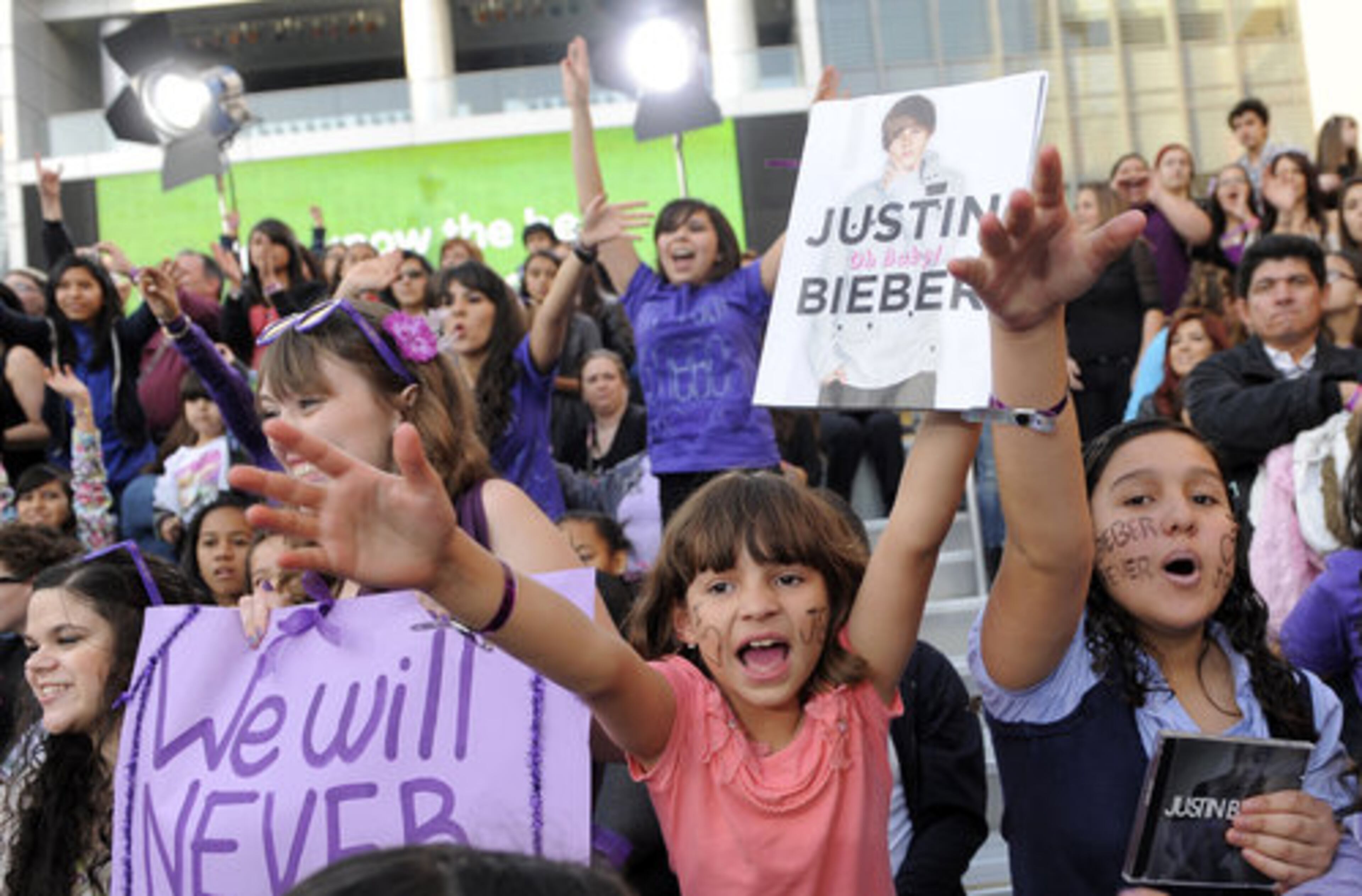 Osiris Guinea, 8, center, and her sister Katherinne, 13, right, wait for Justin Bieber to arrive at the premiere. Parents are encouarged to bring ear plugs when seeing the movie unless they enjoy the sounds of tween girls screaming at the top of their lungs.