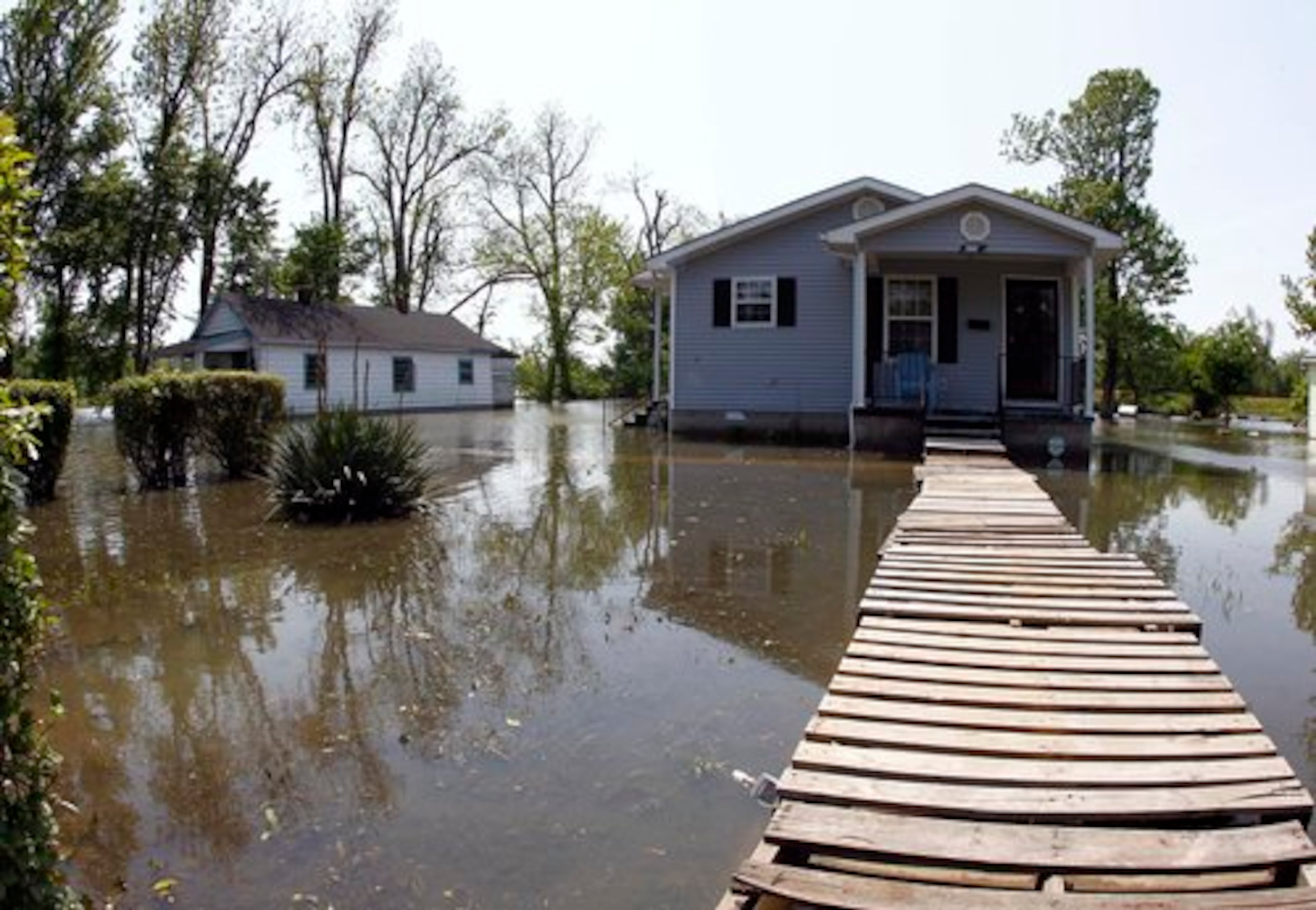 Wooden shipping pallets make a walkway to a home as it sits flooded Saturday, May 7, 2011 in Tiptonville, Tenn, as Memphis readied for the mighty Mississippi to bring its furor to town.