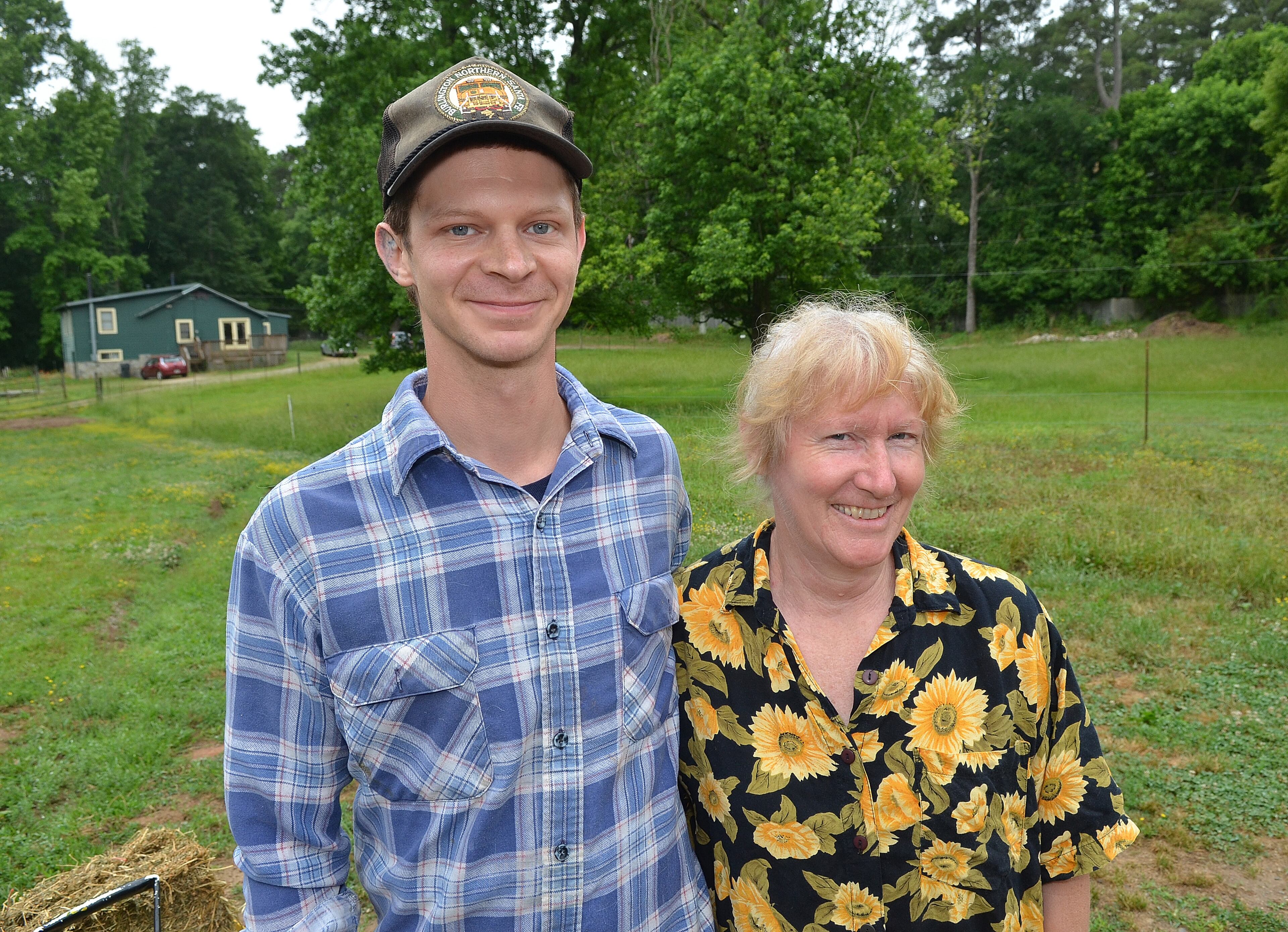 Barn manager and project coordinator Adam Pendergrast and owner Mary Rigdon at Decimal Place Farm in Conley. Farm days can start at 4 a.m. or 6:30 a.m., depending on what chores are required for the day. (Chris Hunt/Special)