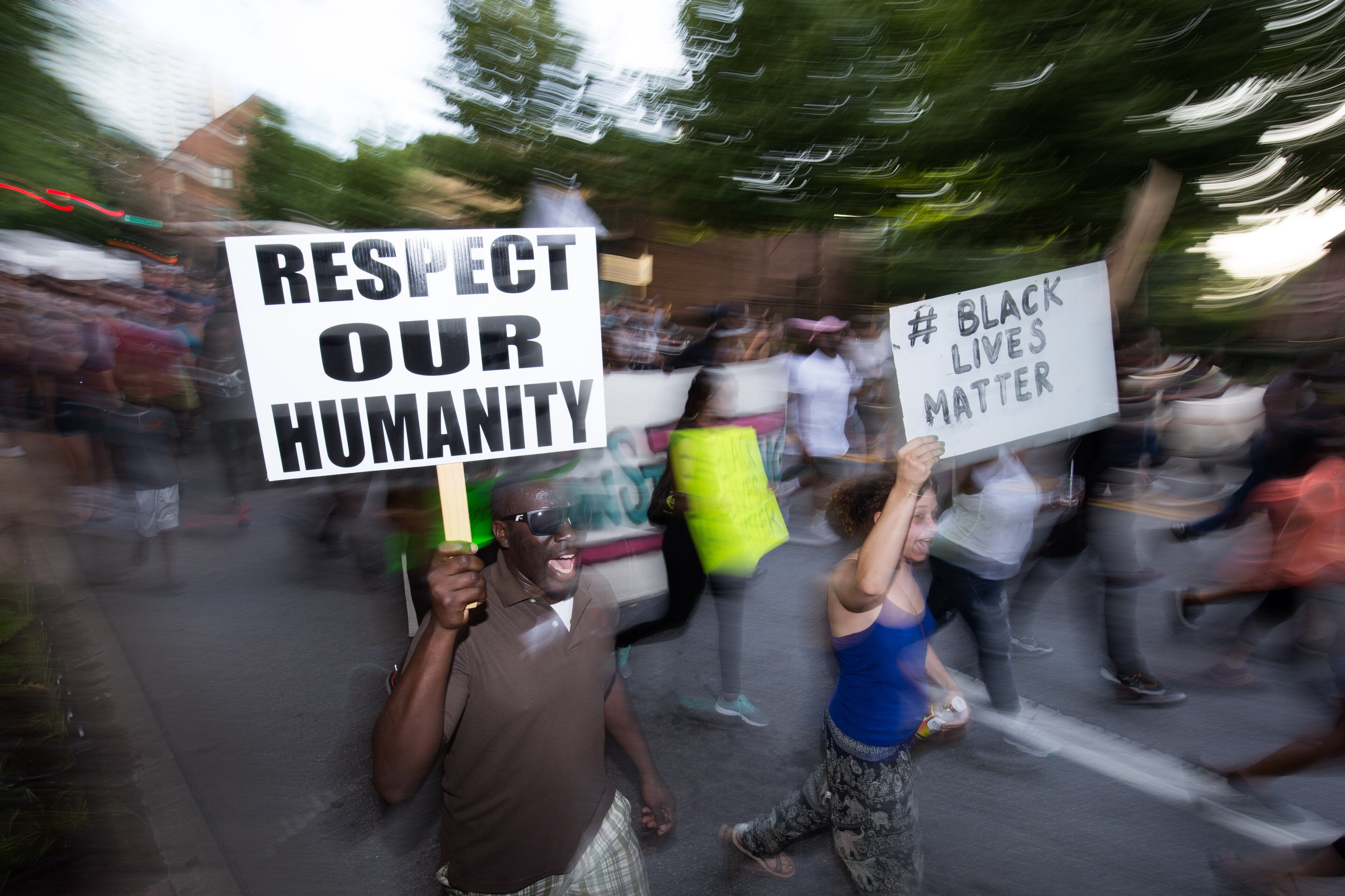Demonstrators carry signs as they march down Peachtree Street to Piedmont Park, Thursday, July 7, 2016, in Atlanta. Demonstrators gathered in response to the death of 37-year-old Alton Sterling, who was killed by Baton Rouge police outside of a convenience store where he was selling CDs and Philando Castile, who was shot and killed when Minnesota police stopped him for a traffic violation on Wednesday evening. BRANDEN CAMP/SPECIAL