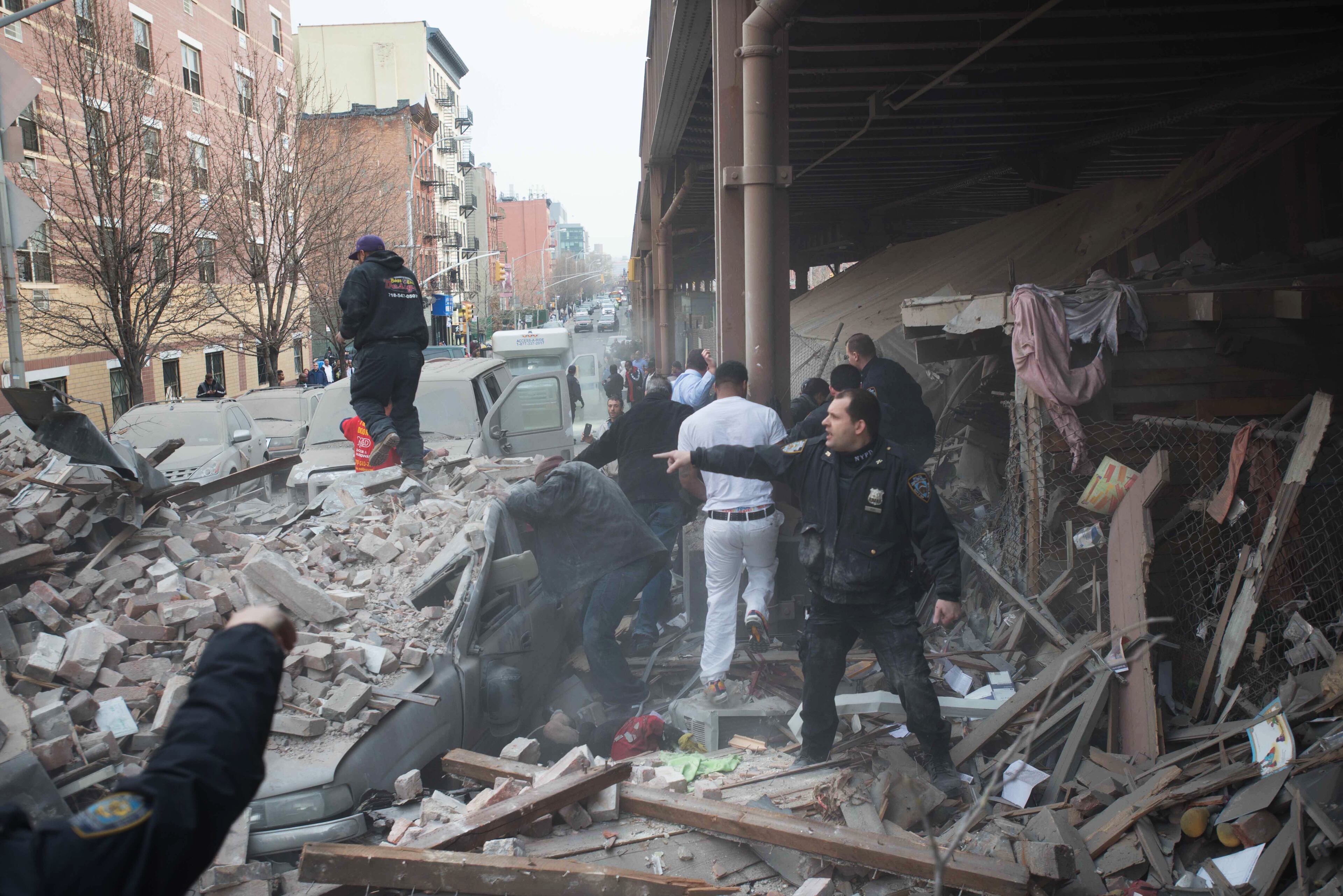 Police respond to the scene of an explosion that leveled two apartment buildings in the East Harlem neighborhood of New York, Wednesday, March 12, 2014. Con Edison spokesman Bob McGee says a resident from a building adjacent to the two that collapsed reported that he smelled gas inside his apartment, but thought the odor could be coming from outside. (AP Photo/Jeremy Sailing)