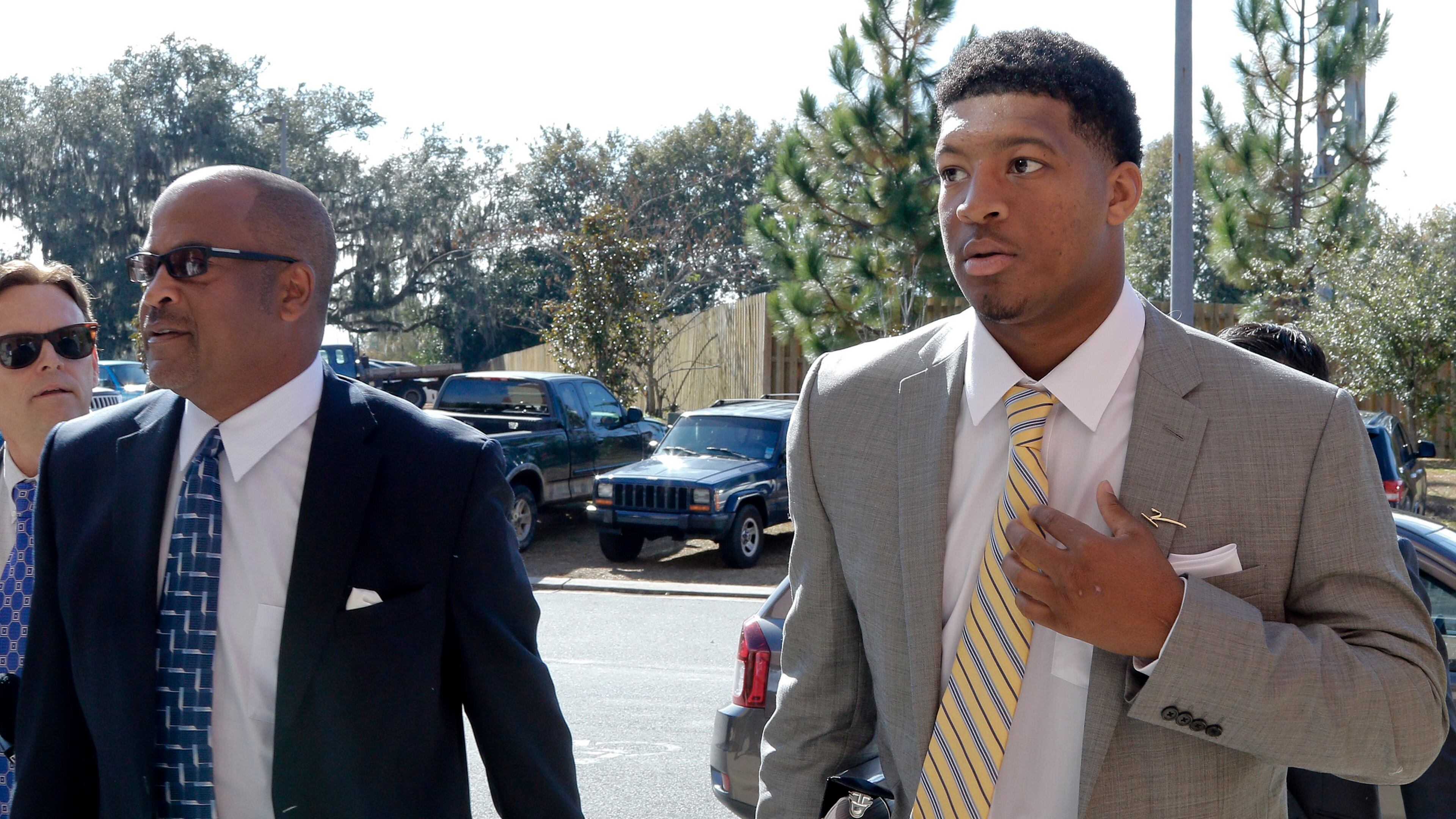 Florida State NCAA college football quarterback Jameis Winston, right, and his attorney David Cornwell arrive at Florida State's Materials Research building for his student code on conduct hearing, Tuesday, Dec. 2, 2014, in Tallahassee, Fla. (AP Photo/Don Juan Moore)
