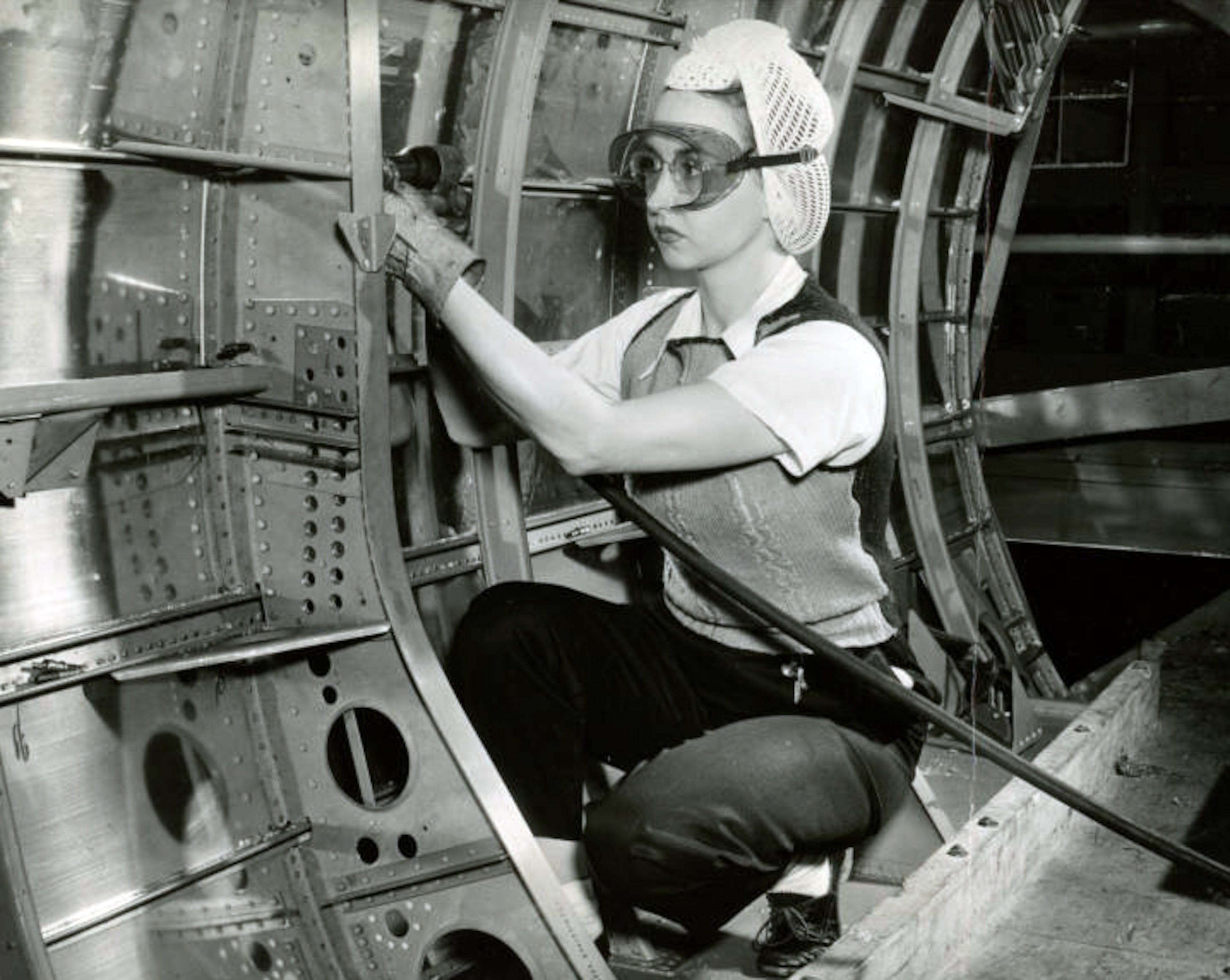 The original caption on this 1945 photo reads: "Young riveter shown at work in the Bell Bomber plant in 1945, helping make B-29's for use in World War 2." The plant was located in Marietta.