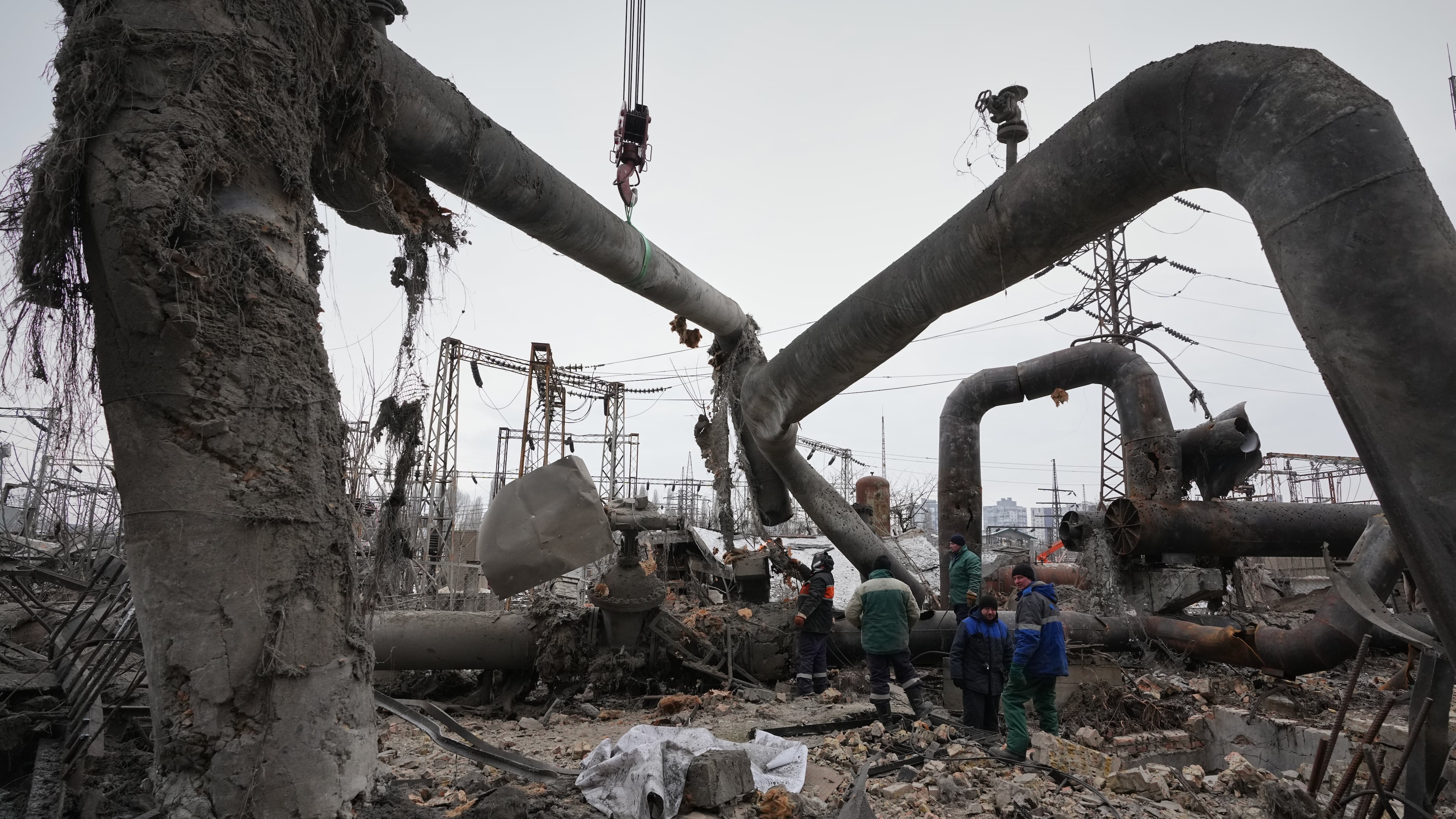 Workers clean up damage at Darnytsia Thermal Power Plant after a Russian attack in Kyiv, Ukraine, Wednesday, Feb. 4, 2026. (AP Photo/Sergei Grits)