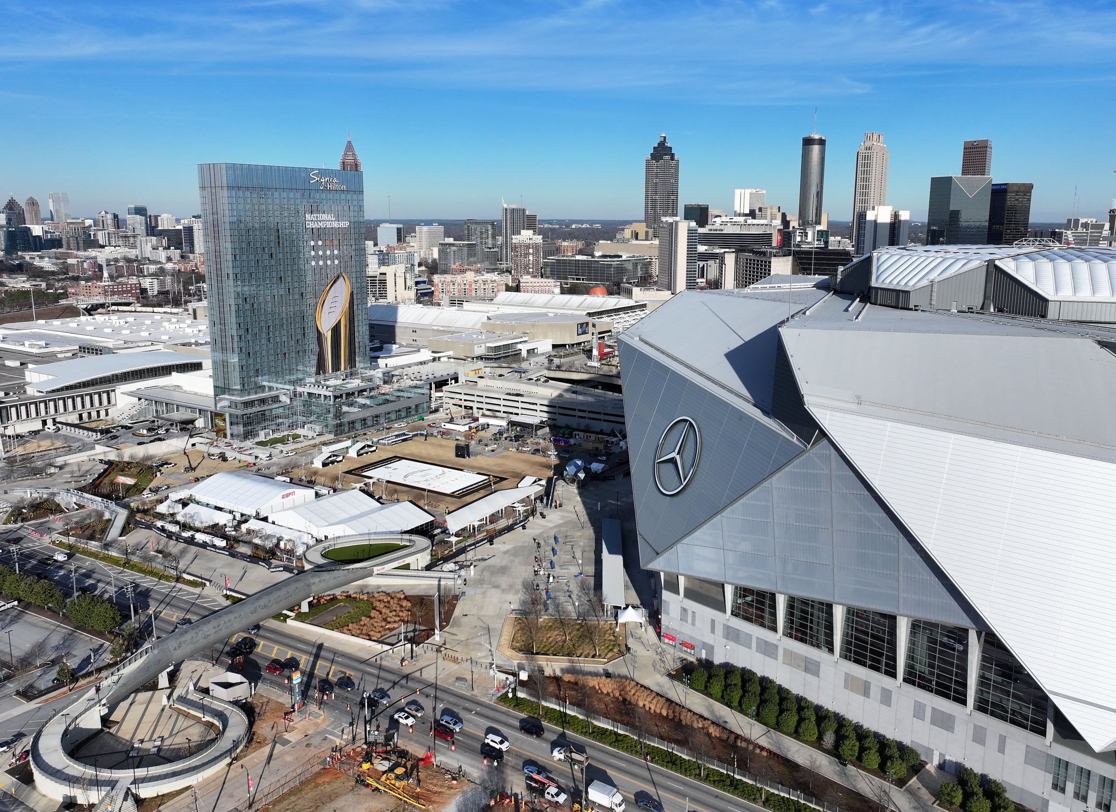 Aerial photo shows the Mercedes-Benz Stadium and Signia by Hilton Atlanta Georgia World Congress Center decorated with College Football Championship logos ahead of the 2025 College Football National Championship between Notre Dame and Ohio State, Friday, Jan. 17, 2025, in Atlanta. (Hyosub Shin/AJC)
