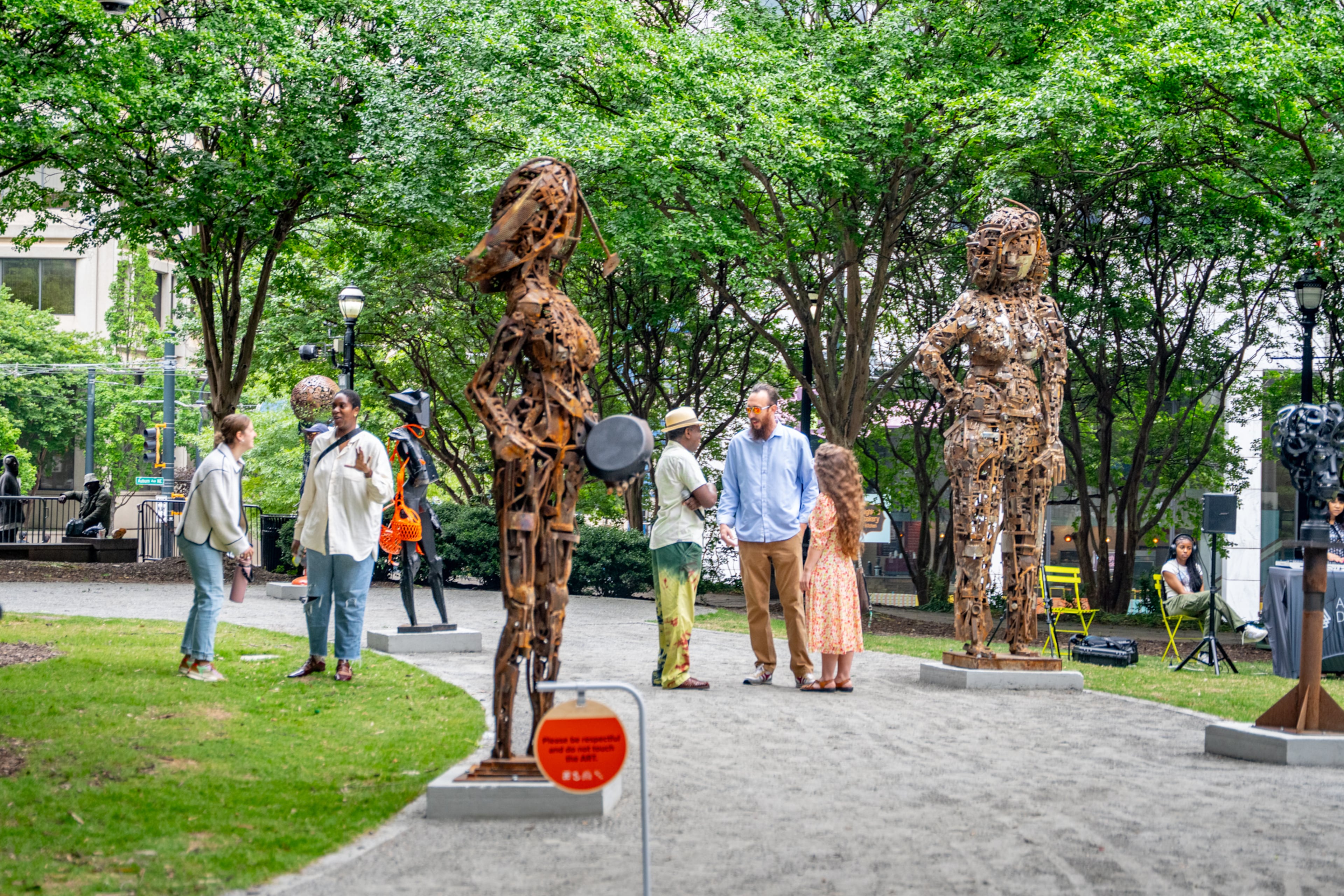Visitors wander among a series of sculptures by Olu Amoda, an artist who places great emphasis on the discarded materials he uses to create his work. (Jeffrey Moustache/AJC)