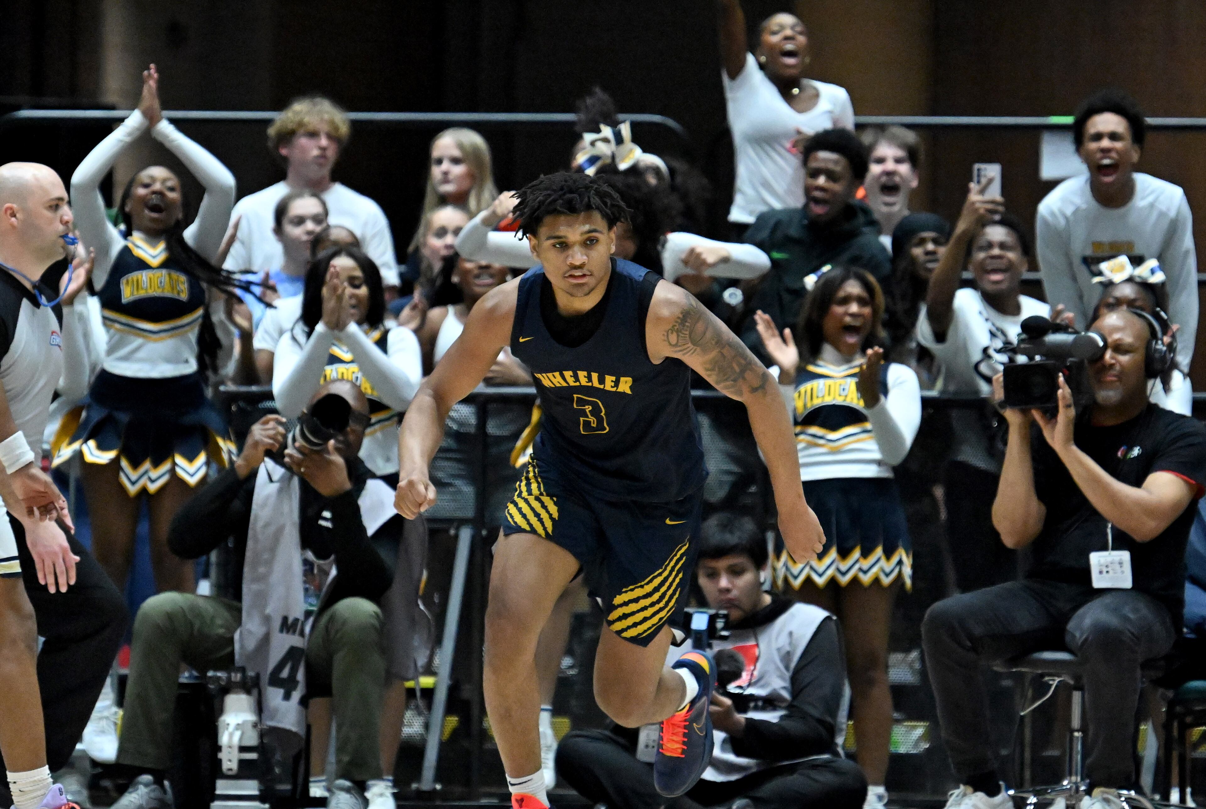 Wheeler Colben Landrew (3) reacts after dunking the ball against Pebblebrook during the second half in Class 6A Boys GHSA State Championship at the Macon Coliseum, Saturday, March 14, 2026, in Macon. Wheeler won 62-52 over Pebblebrook. (Hyosub Shin/AJC)