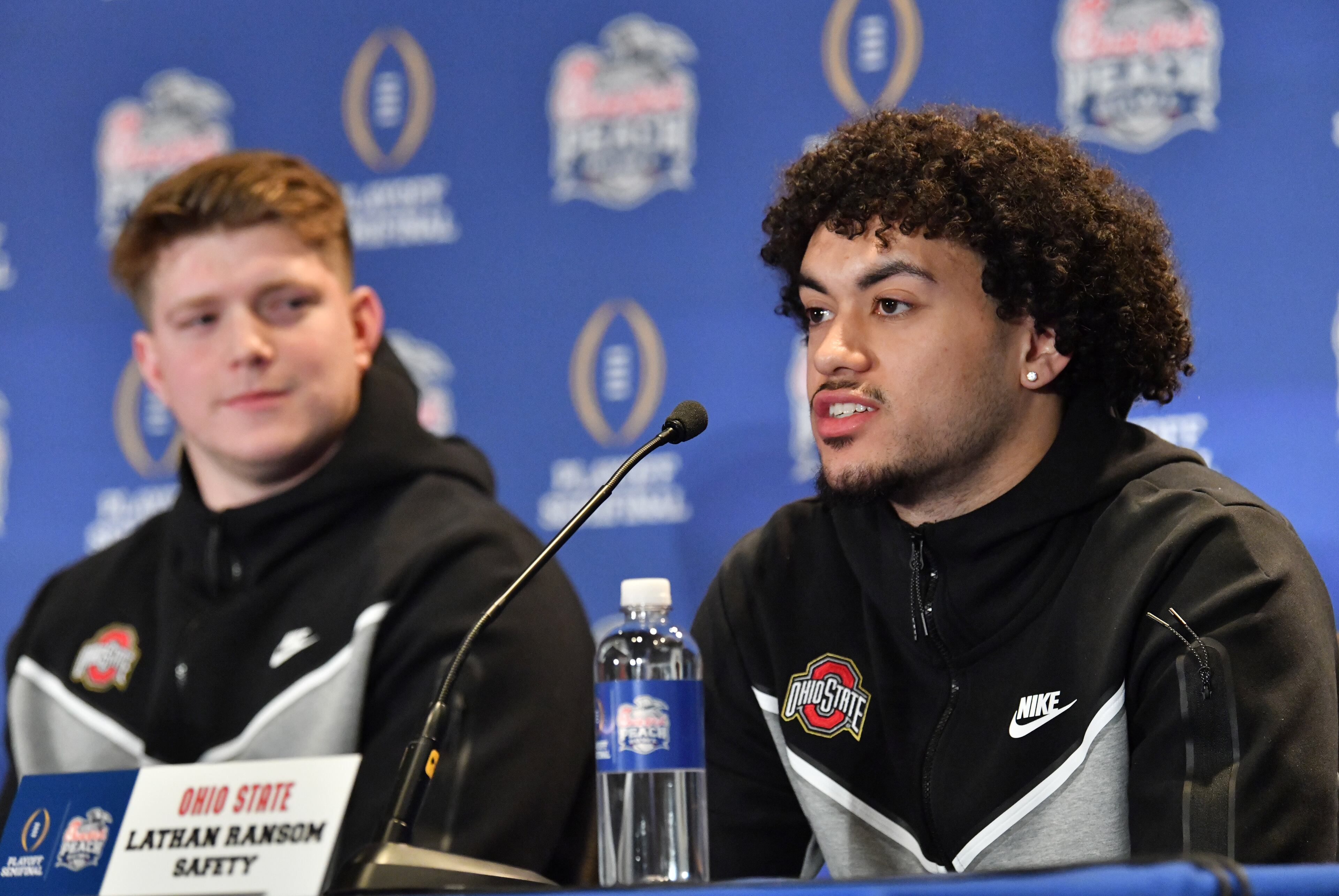 Safety Lathan (right) answers a question during Ohio State's press conference ahead of the Chick-fil-A Peach Bowl at The Westin Peachtree Plaza in Atlanta on Wednesday, Dec. 28, 2022. (Hyosub Shin / Hyosub.Shin@ajc.com)