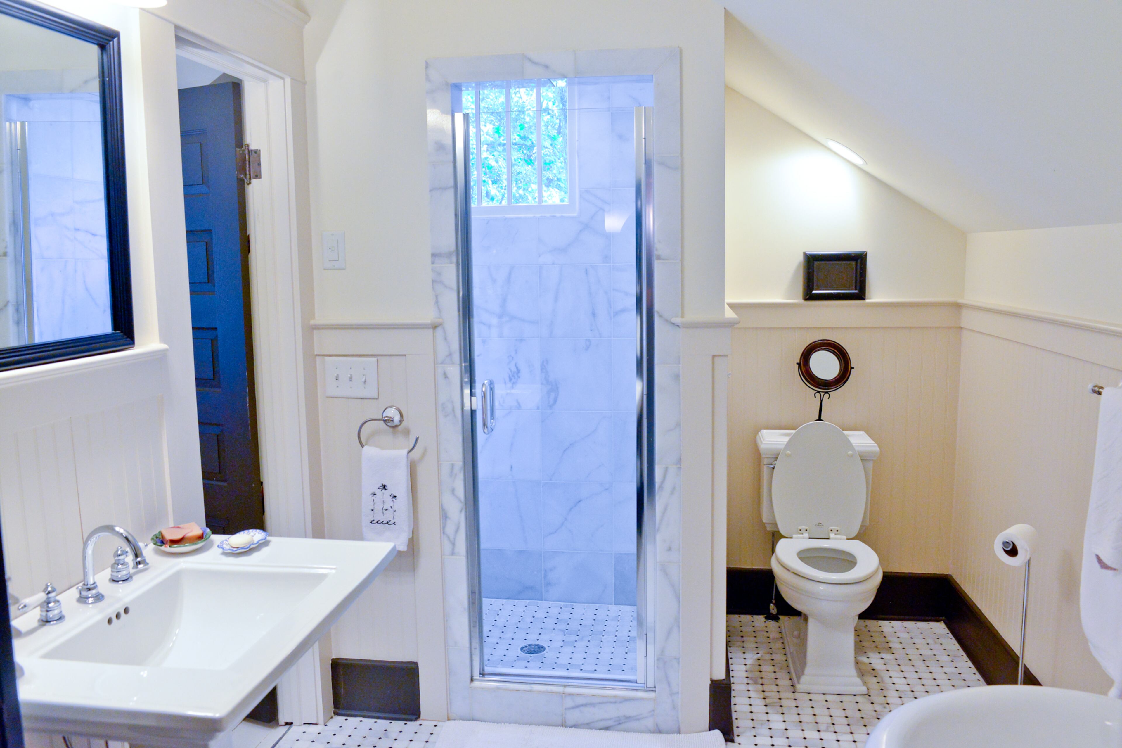 Classic fixtures, tile work and a standalone tub remind guests that they are staying in a 100-year-old home. The separate shower lets them know the upstairs guest bathroom is a recent addition.