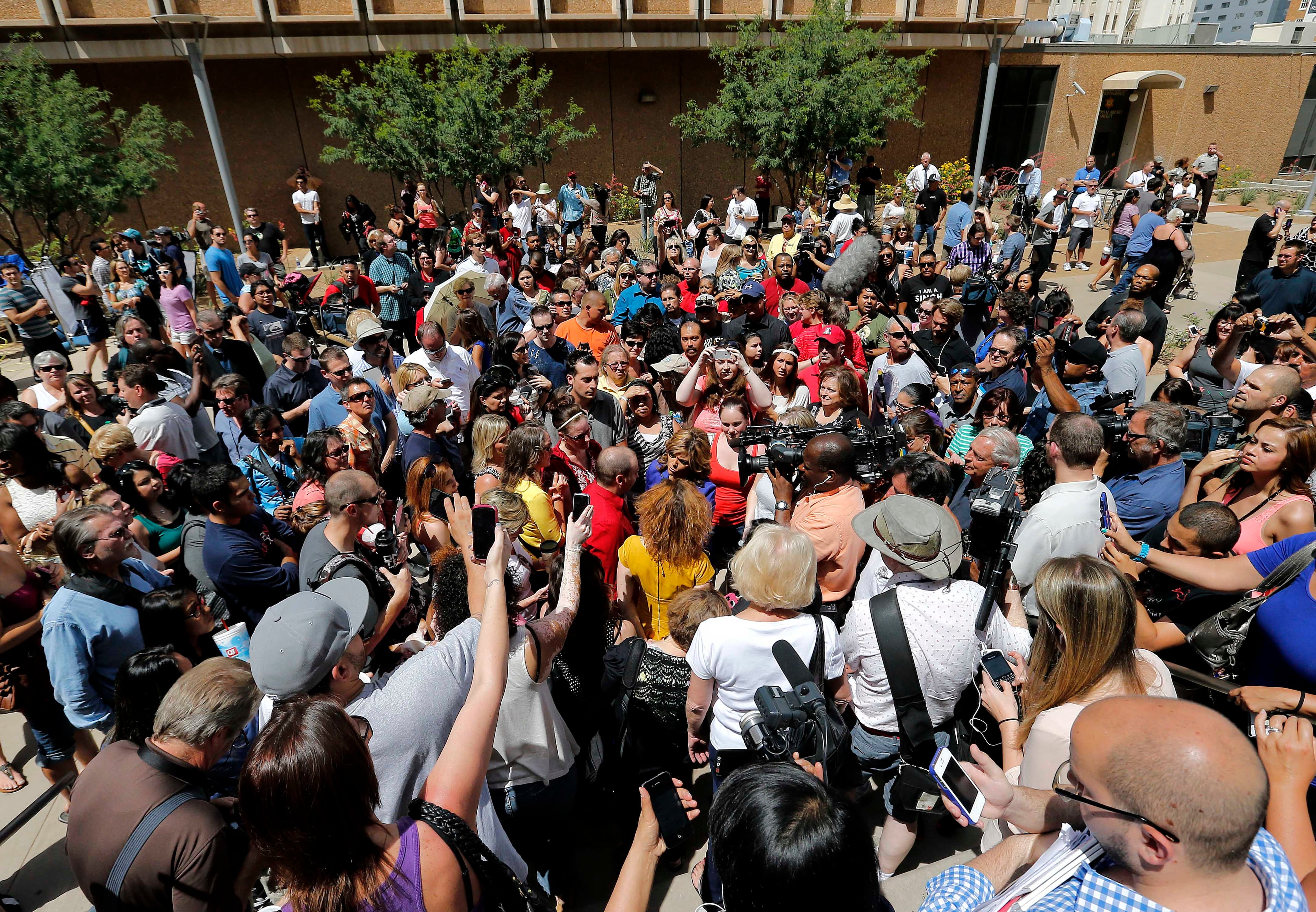 Spectators react in Phoenix to the guilty verdict in the trial of Jodi Arias.