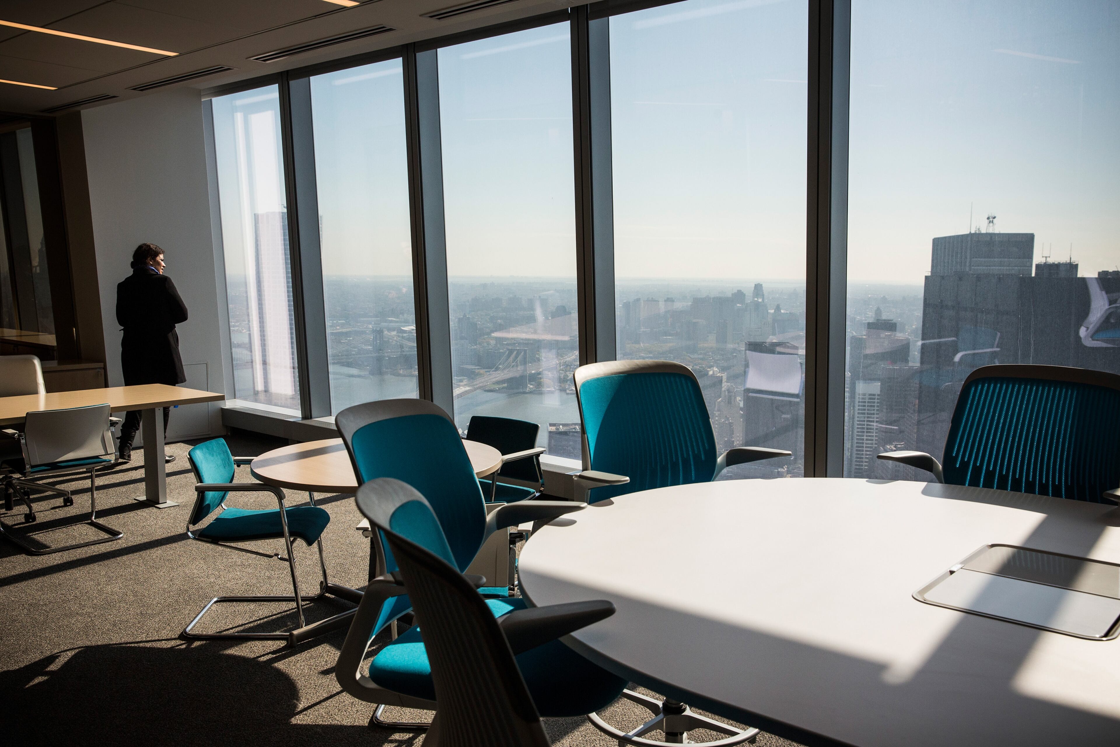 Members of the media explore a model office, used to exhibit what a business space could look like on the 63rd floor of One World Trade Center, which opens for business today, on November 3, 2014 in New York City. The skyscraper is 104 stories tall and cost $3.9 billion; it opens more than 13 years after the terrorist attacks of September 11, 2001, destroyed the original World Trade Center buildings. (Photo by Andrew Burton/Getty Images)