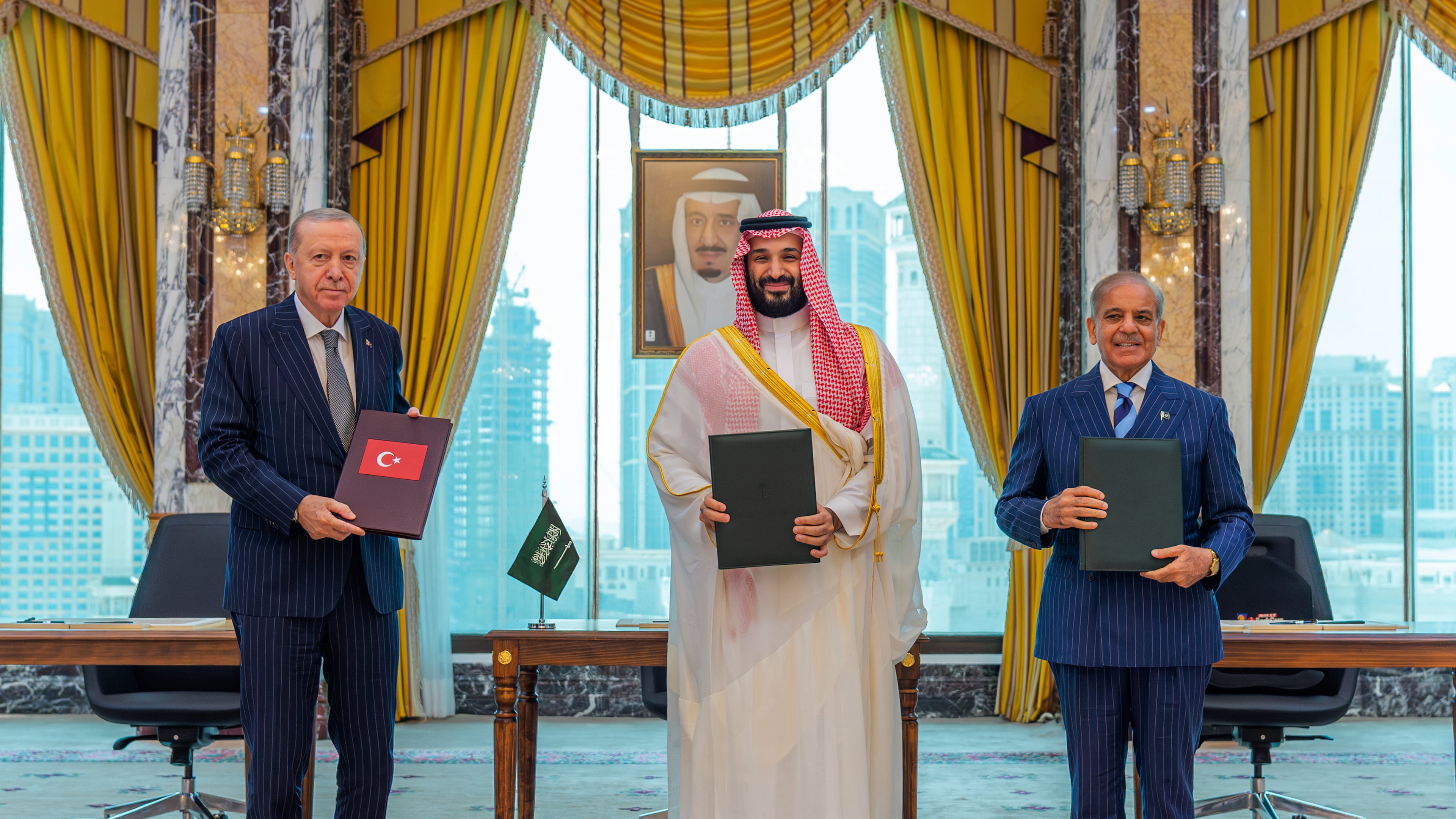 From left, Turkish President Recep Tayyip Erdogan, Saudi Crown Prince Mohammed bin Salman and Pakistani Prime Minister Shehbaz Sharif pose after signing a trilateral defense agreement in Mecca, Saudi Arabia, Friday, Aug. 7, 2026. (Saudi Press Agency via AP)
