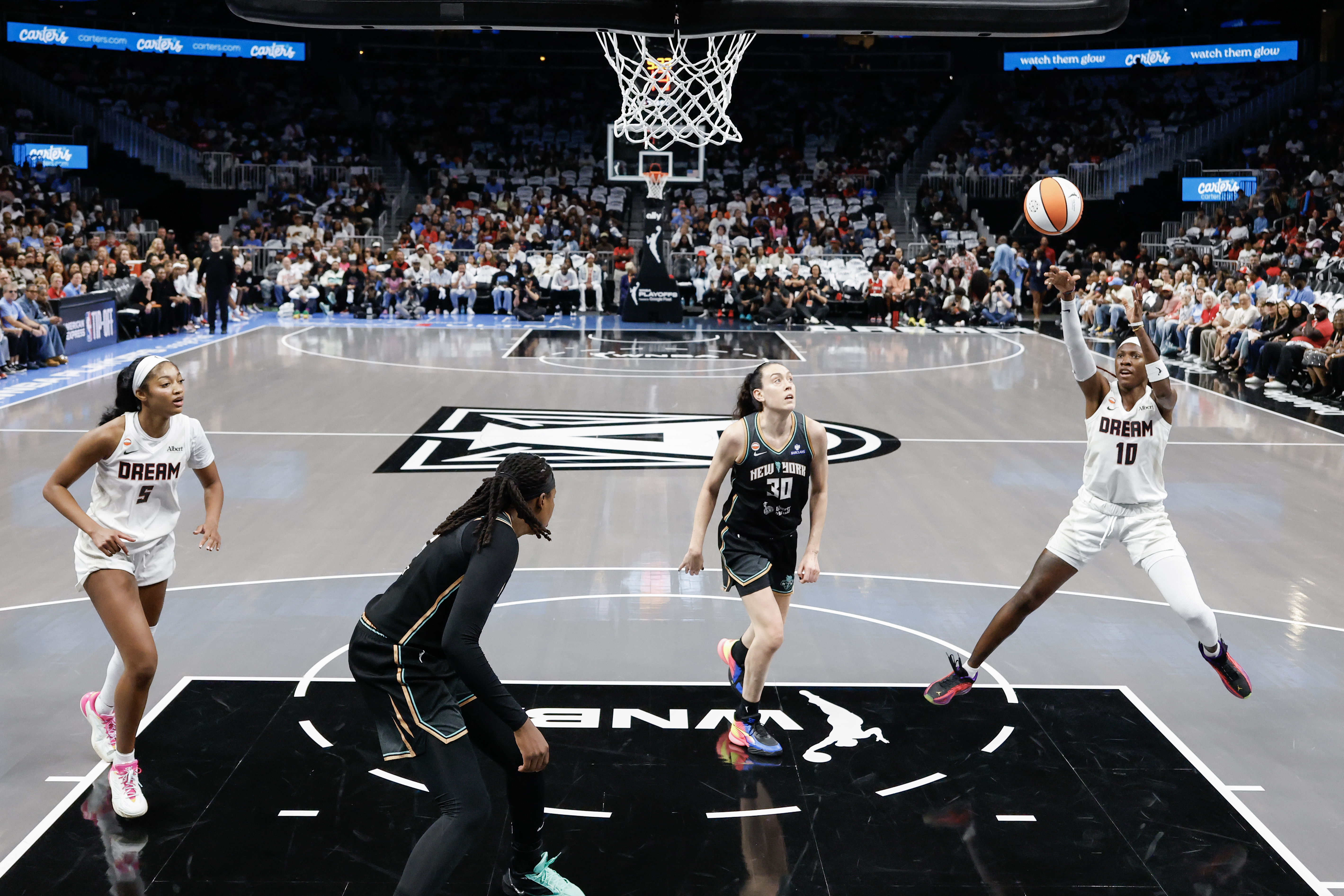Atlanta Dream guard Rhyne Howard (10) shoots against New York Liberty forward Breanna Stewart (30) during the first half of a WNBA semifinal playoff game 1 between the Atlanta Dream and the New York Liberty, Sunday, Oct. 4, 2026, in Atlanta. (Erik S. Lesser for the AJC)