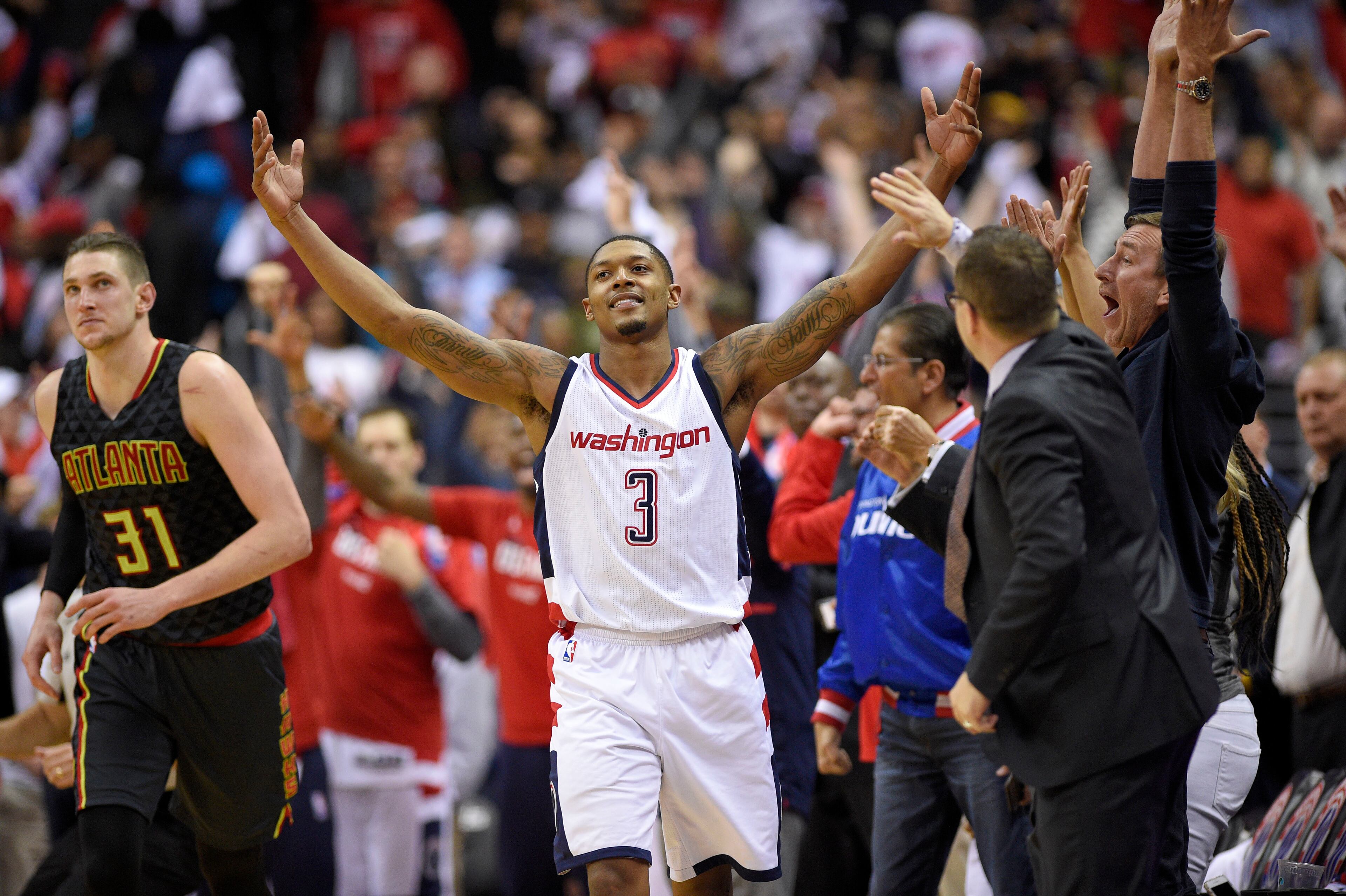 Washington Wizards guard Bradley Beal (3) reacts after he made a 3-point basket during the second half in Game 2 of a first-round NBA basketball playoff series, as Atlanta Hawks forward Mike Muscala runs nearby, Wednesday, April 19, 2017, in Washington. The Wizards won 109-101. (AP Photo/Nick Wass)