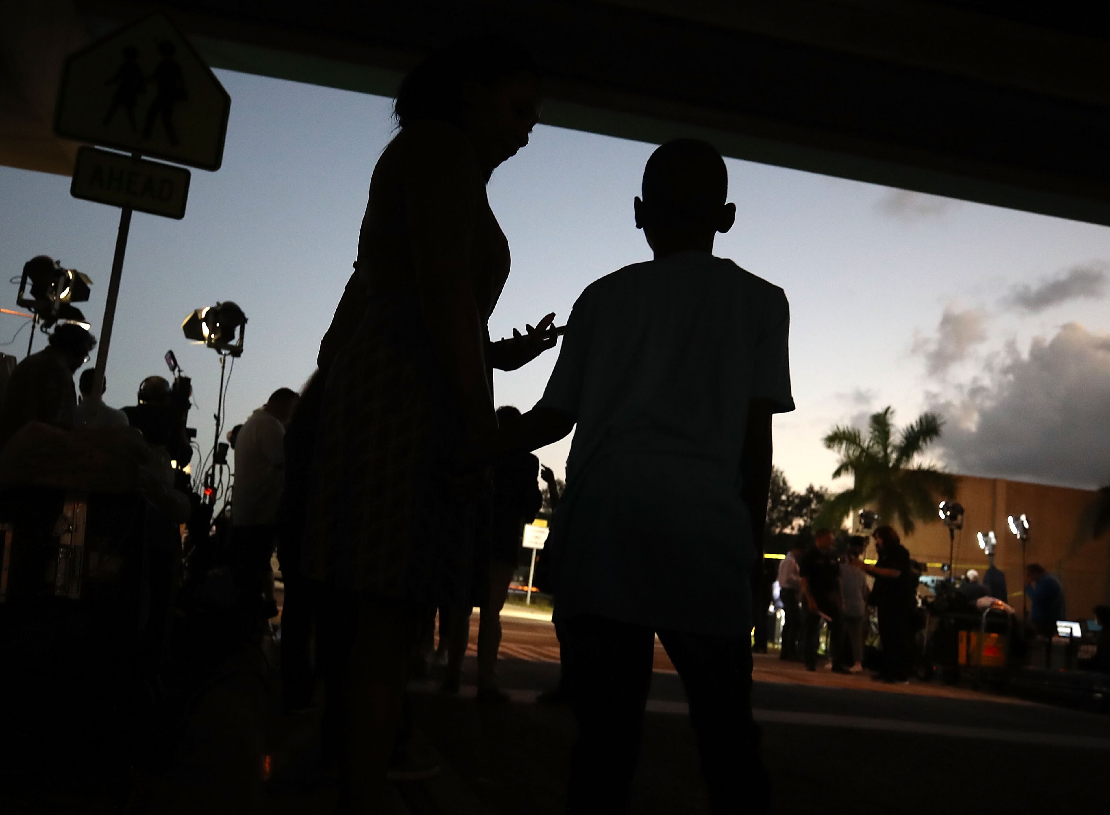 PARKLAND, FL - FEBRUARY 15: Sheree Spaulding (L), stands with her 15-year-old son, Justin Spauling, who is a 9th grader at the Marjory Stoneman Douglas High School where 17 people were killed by a gunman yesterday, on February 15, 2018 in Parkland, Florida. Police arrested the suspect after a short manhunt, and have identified him as 19-year-old former student Nikolas Cruz. (Photo by Mark Wilson/Getty Images)