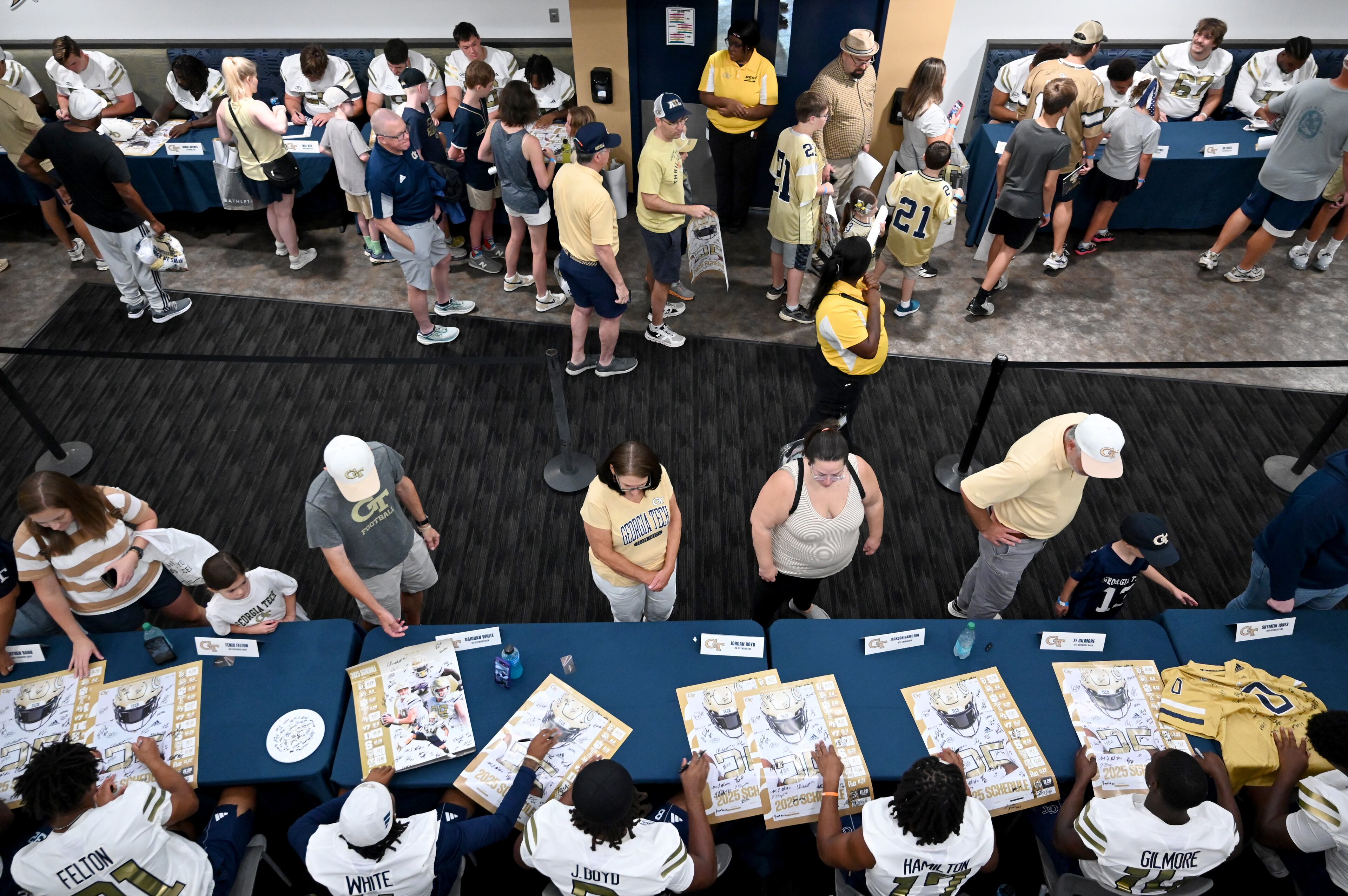 Georgia Tech football players sign autographs for event attendees during the annual “First Saturday on The Flats” at Bobby Dodd Stadium, Saturday, August 2, 2025, in Atlanta. The Flats provides Tech fans with the opportunity to engage with their favorite Yellow Jackets ahead of the upcoming 2025 season. The event offers a variety of entertaining activities for the whole family, including a DJ, autograph opportunities, tailgate games and interactive experiences right on the field at Bobby Dodd Stadium. (Hyosub Shin / AJC)