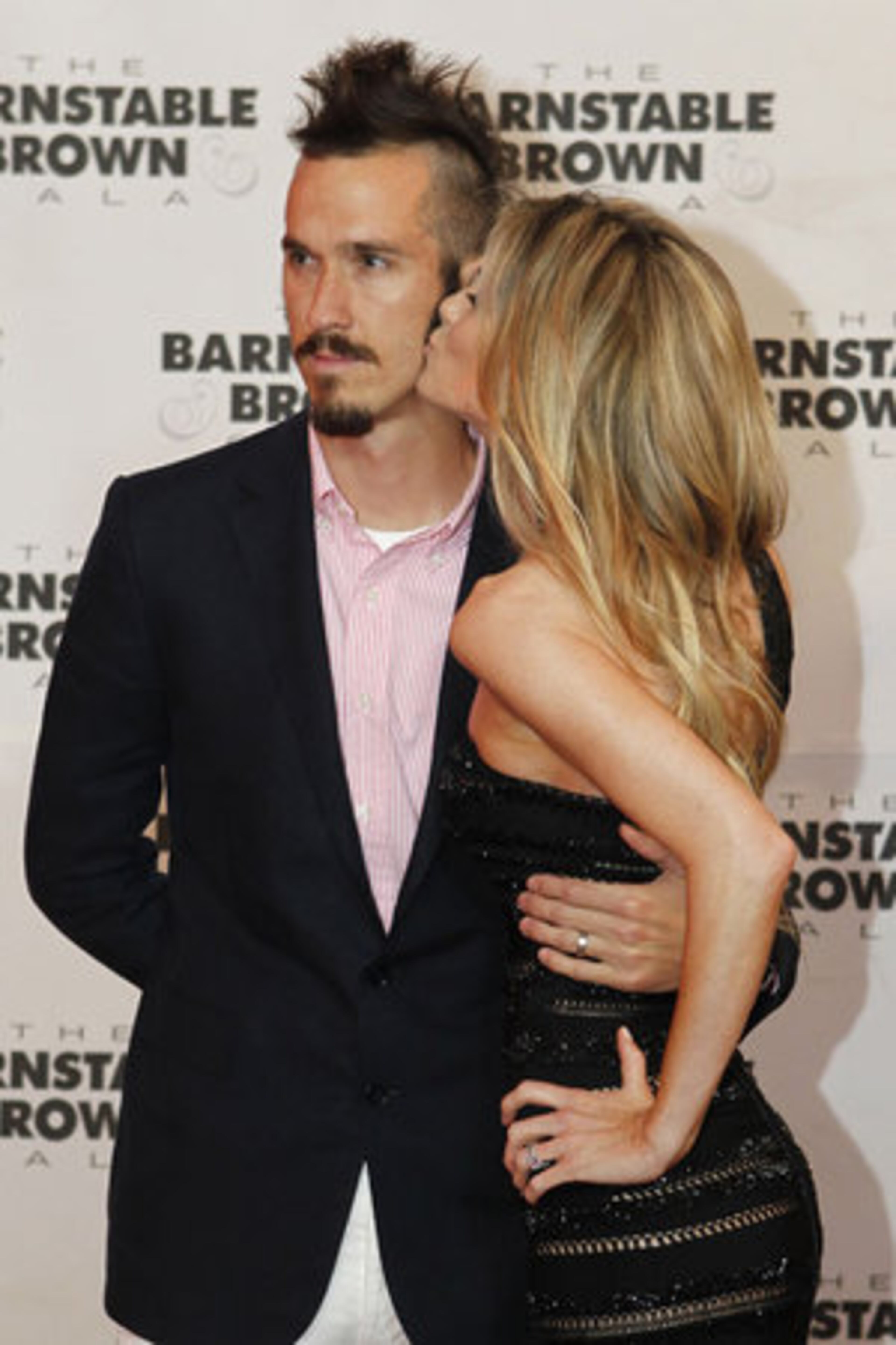 Marisa Miller gives husband and producer Griffin Guess a smooch as they arrive for the party.