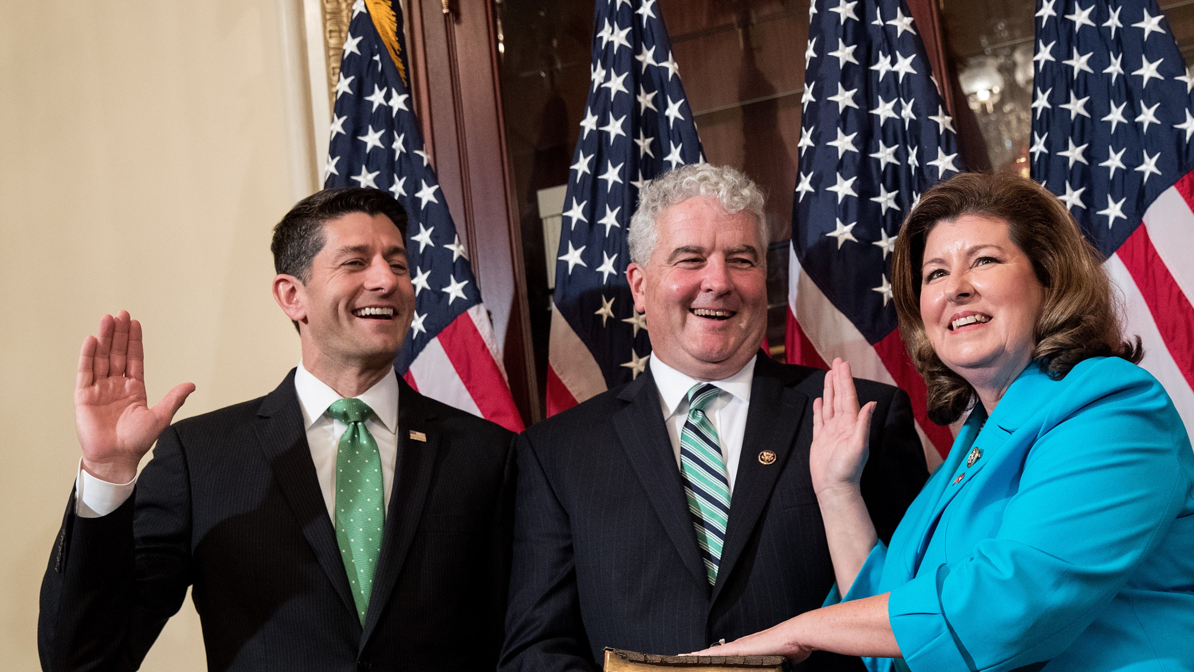 U.S. House Speaker Paul Ryan, from left, Steve Handel and U.S. Rep. Karen Handel, R-Ga., participate in a ceremonial swearing-in Monday on Capitol Hill. (Photo by Drew Angerer/Getty Images)