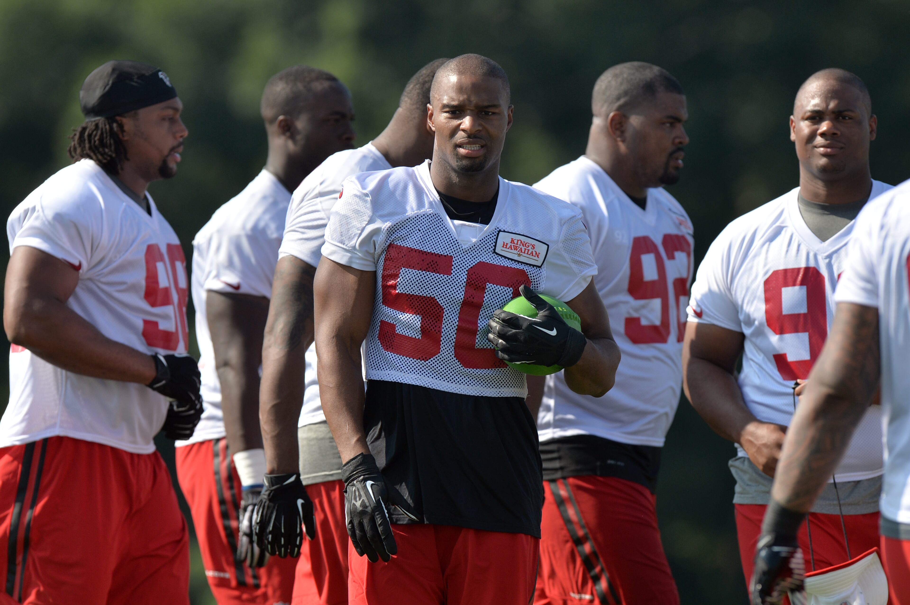 Atlanta Falcons defensive end Osi Umenyiora (50) takes a glance at the festivities during training camp on Friday, July 25, 2014.