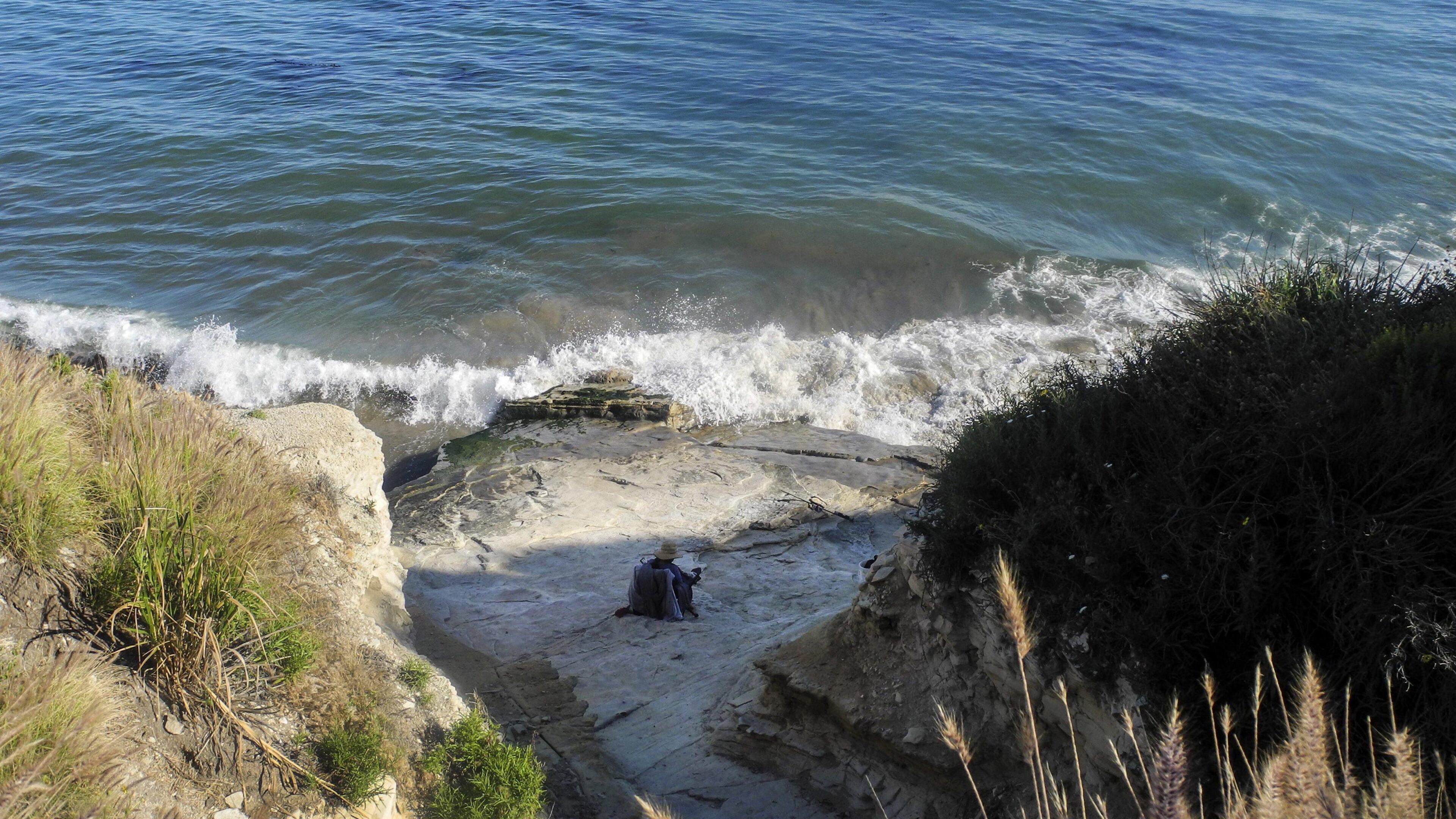 A beachgoer enjoys the water by Aniso Trail between California's Refugio State Beach and El Capitan State Beach on May 20, 2017. (Denise Florez/Los Angeles Times/TNS)