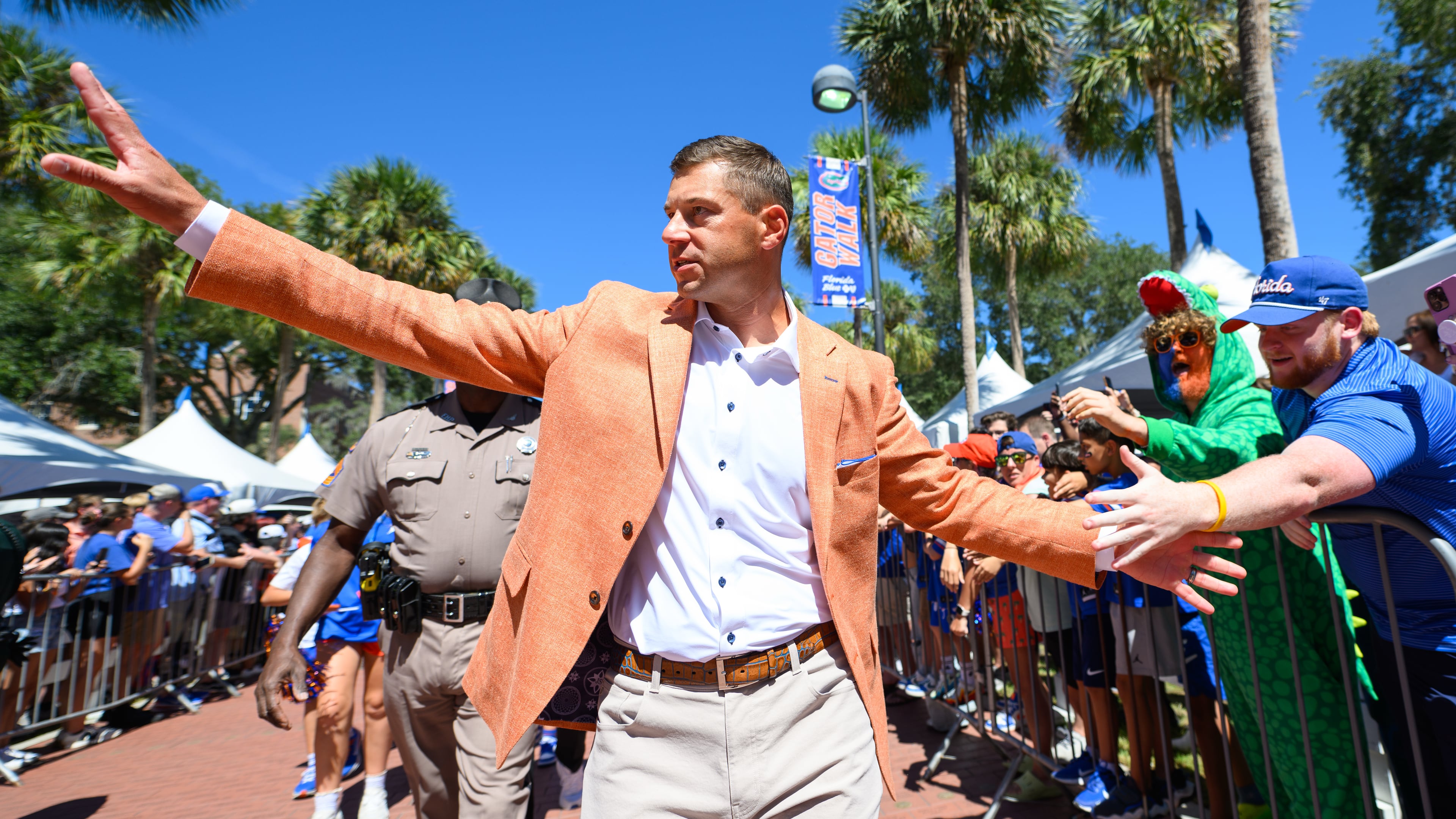 Florida head coach Jon Sumrall greets fans along Gator Walk before an NCAA college football game against Mississippi, Saturday, Sept. 26, 2026, in Gainesville, Fla. (AP Photo/Noah Lantor)