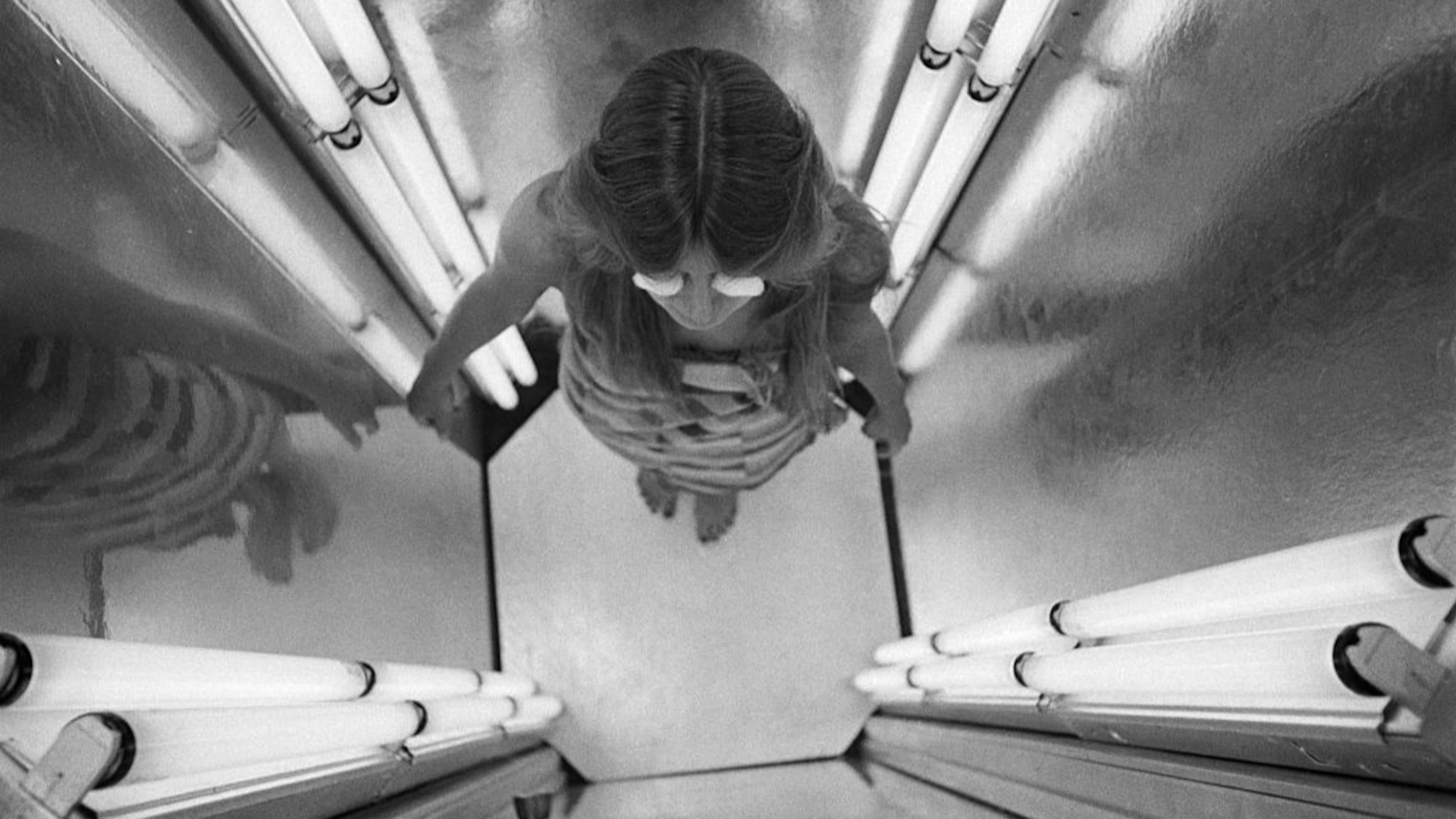 A photo of a 1980s-era private tanning booth at a salon in St. Louis. The booth had 24 ultra-violet lights and was cutting edge at the time. Police arrested a man in south Florida for allegedly filming a naked a woman through a room divider as she was getting ready to get in a stand-up tanning bed.