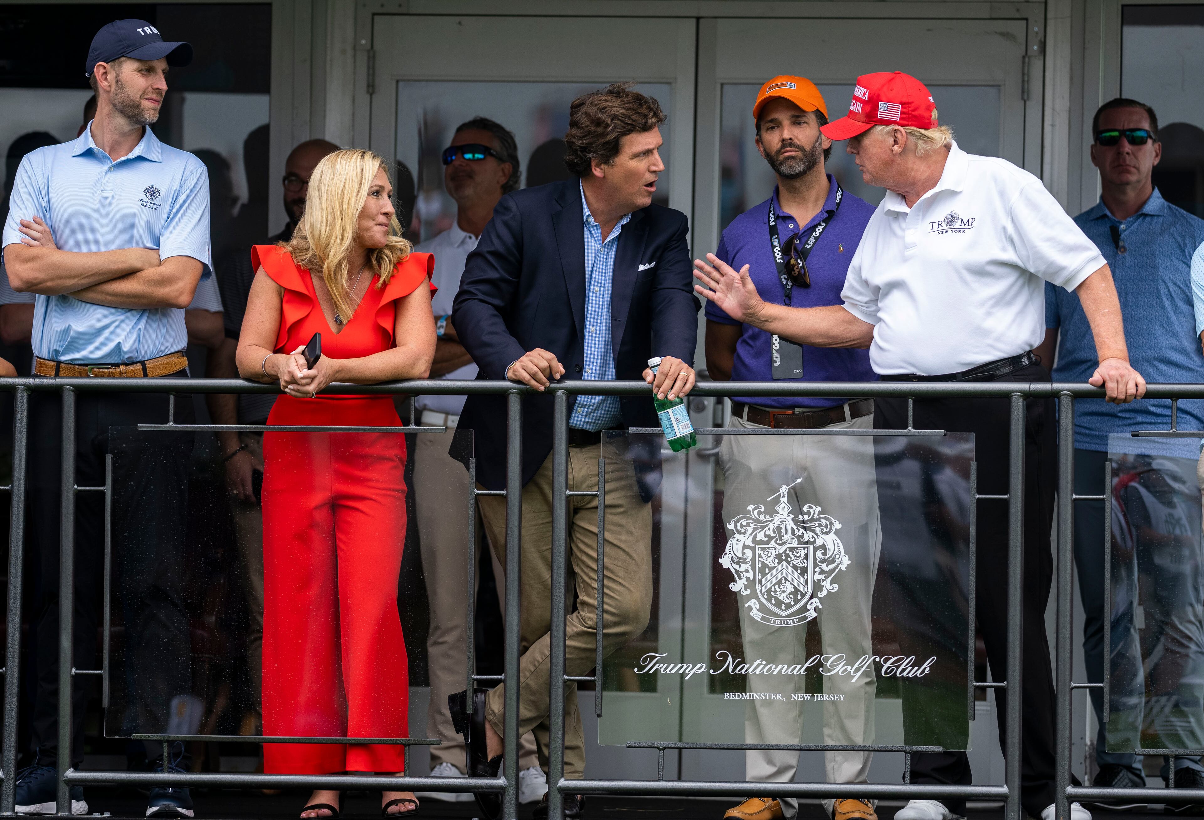 Eric Trump, Rep. Marjorie Taylor Greene (R-Ga.), Tucker Carlson, Donald Trump Jr. and former President Donald Trump at Trump National Golf Club in Bedminster, N.J., July 31, 2022. Carlson recently aired video footage of the Jan. 6, 2021 attack on the U.S. Capitol. (Doug Mills/The New York Times)