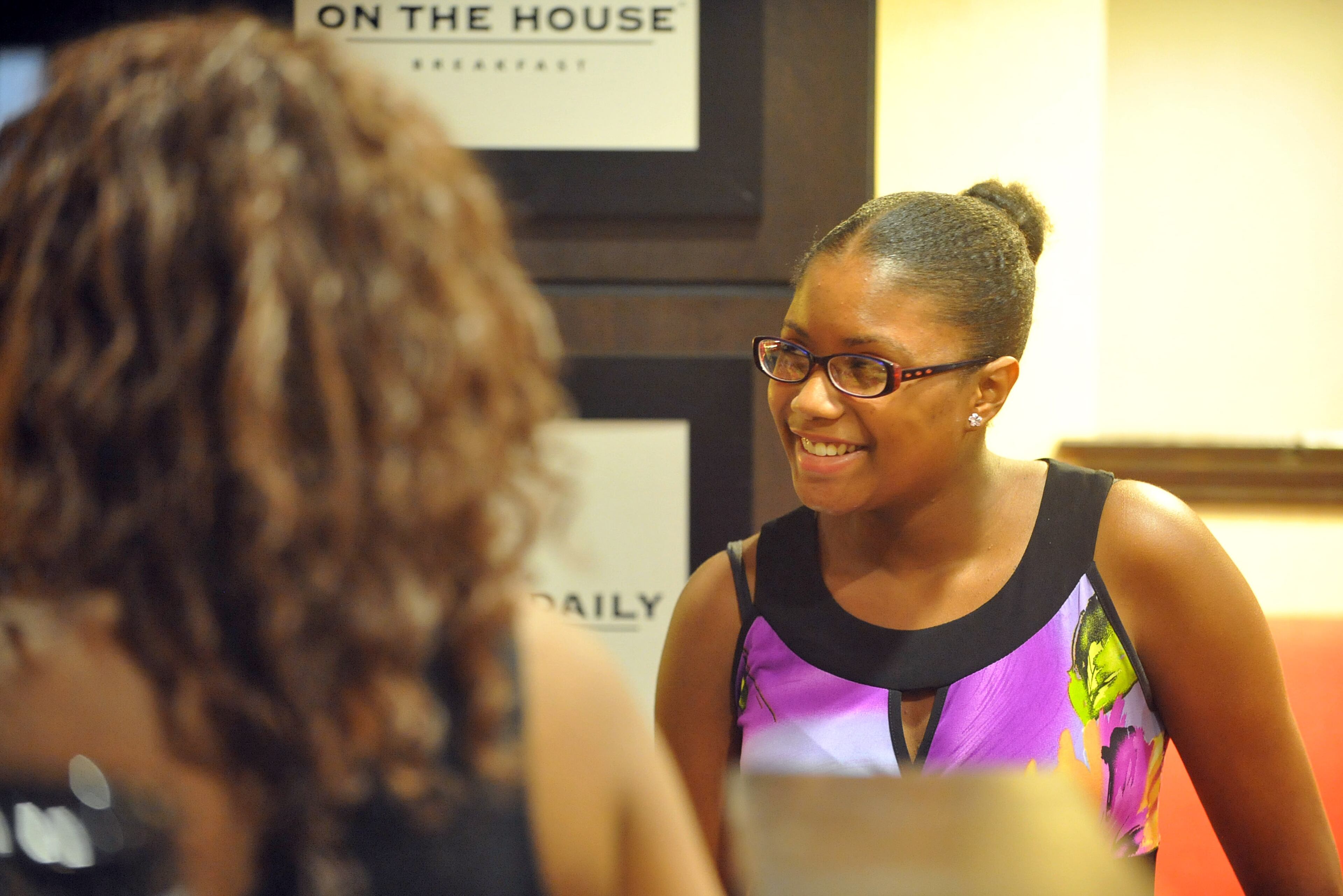 Aaron smiles as she talks with family members at the hotel. KENT D. JOHNSON / KDJOHNSON@AJC.COM
