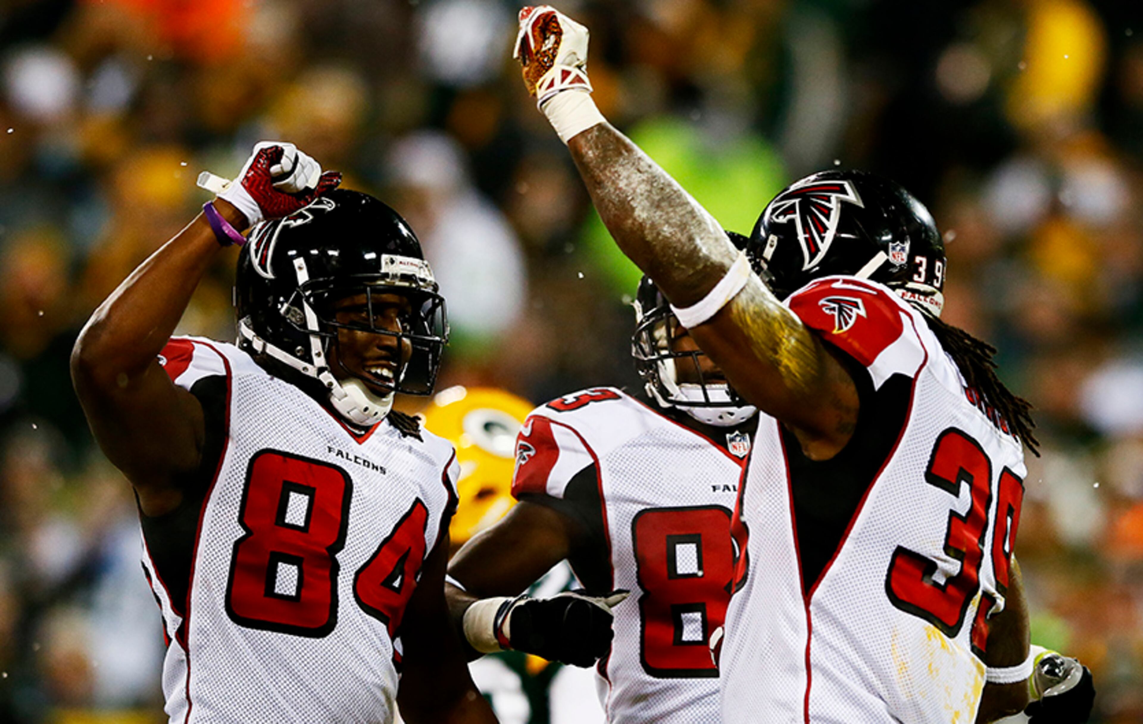 Falcons running back Steven Jackson (39) celebrates his first quarter touchdown with teammates Roddy White (84) and Harry Douglas against the Green Bay Packers at Lambeau Field on Dec. 8, 2014 in Green Bay, Wis.