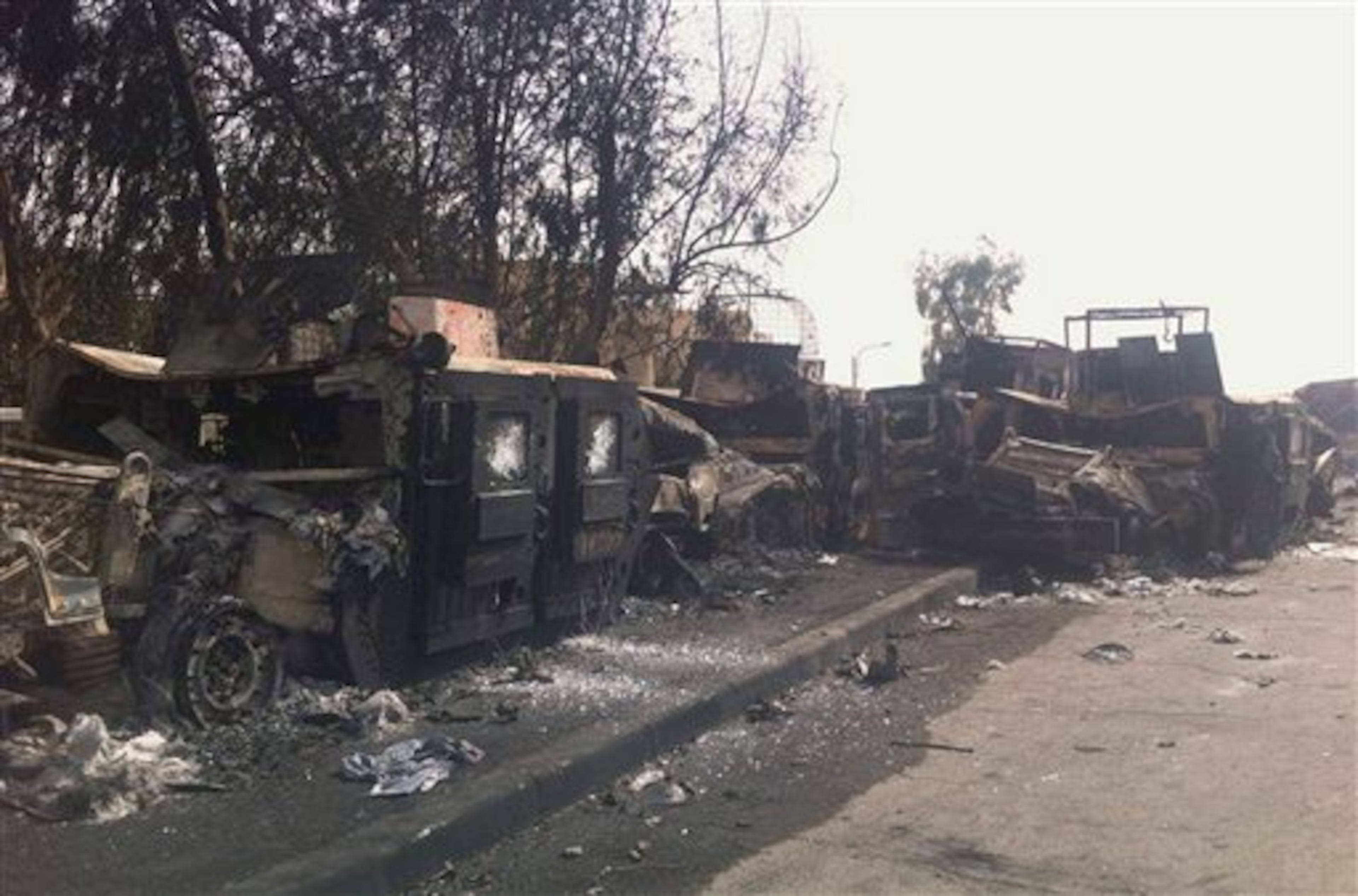 Burned Iraqi army armored vehicles are seen left on a street of the northern city of Mosul, Iraq, Thursday, June 12, 2014. The al-Qaida-inspired group that captured two key Sunni-dominated cities in Iraq this week vowed on Thursday to march on to Baghdad, raising fears about the Shiite-led government's ability to slow the assault following the insurgents' lightning gains. (AP Photo)