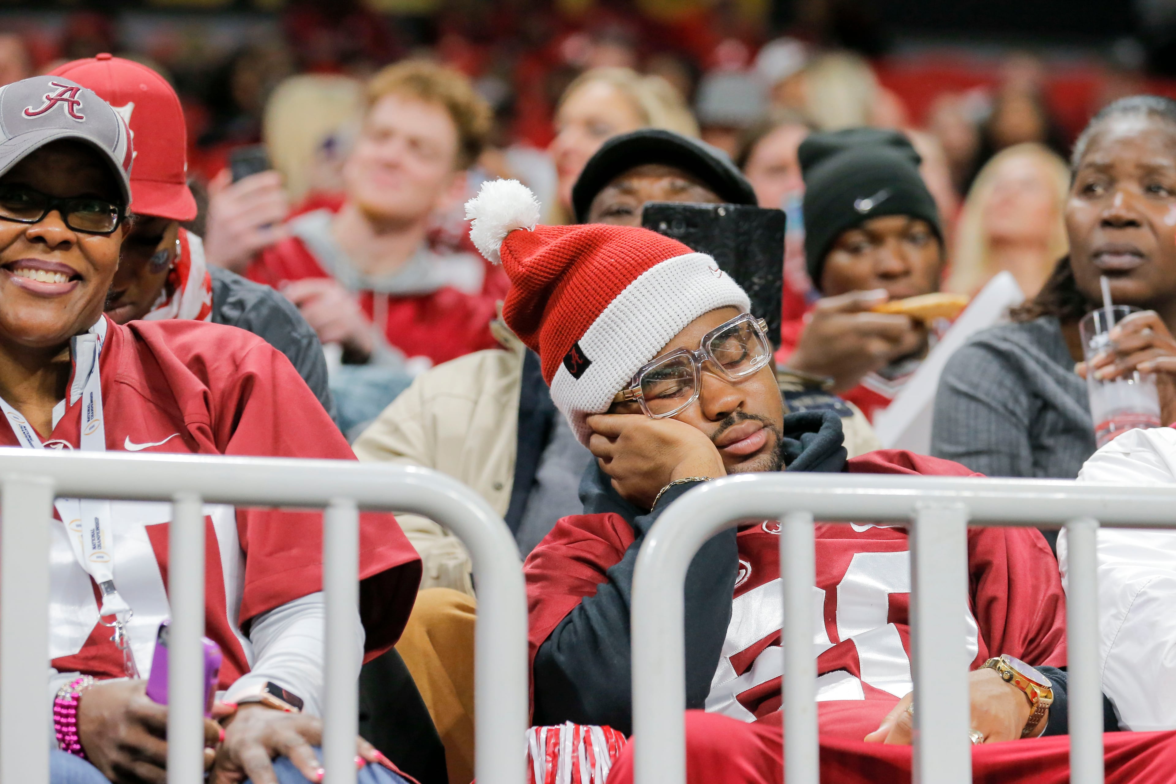 01/08/2018 -- Atlanta, GA - An Alabama Crimson Tide fan takes a nap before the College Football Playoff National Championship at Mercedes-Benz stadium in Atlanta, Monday, January 8, 2018. The Georgia Bulldogs will take on the Alabama Crimson Tide for the 2018 championship title. ALYSSA POINTER/ALYSSA.POINTER@AJC.COM