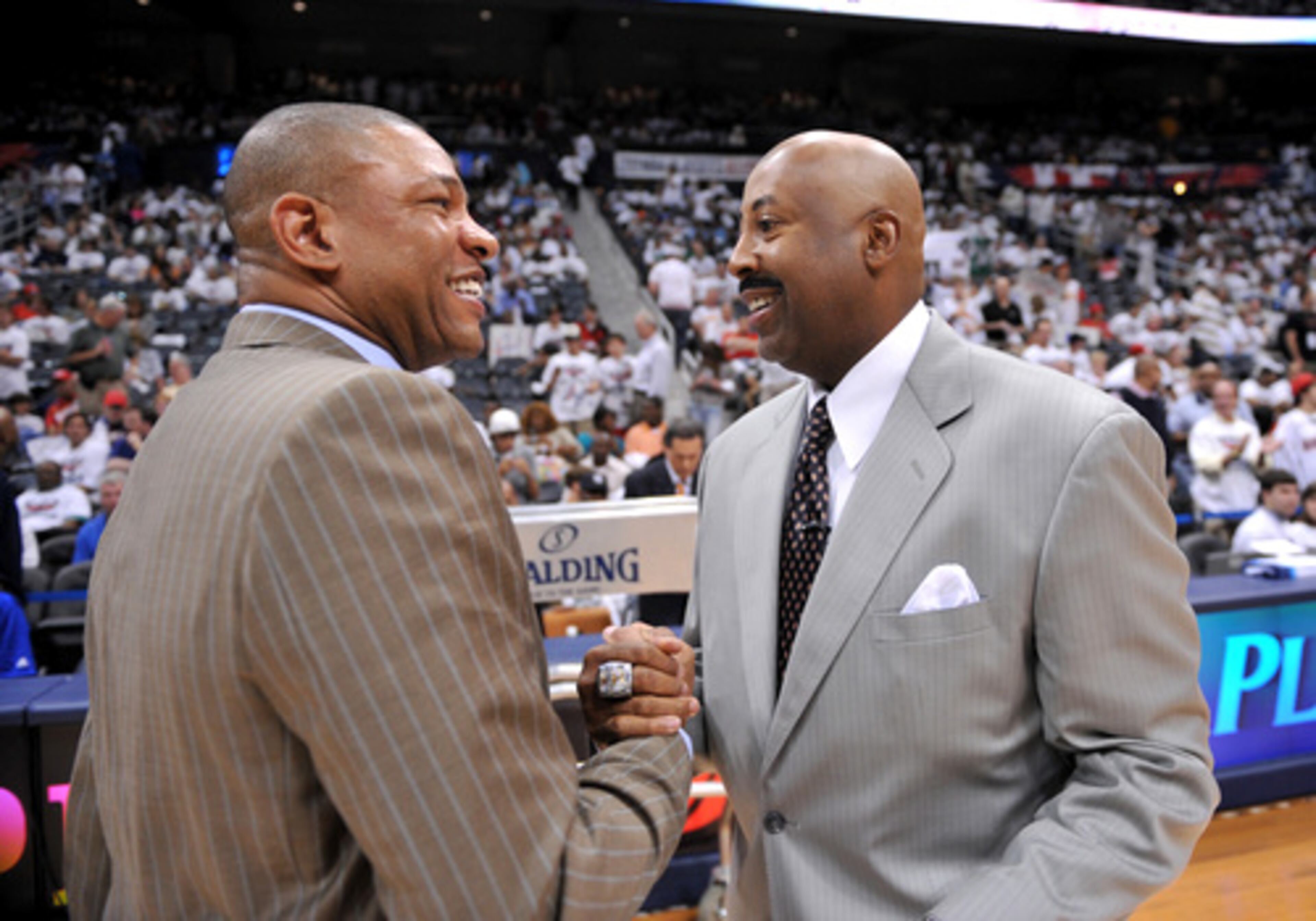 Celtics' head coach Doc Rivers and Hawks' head coach Mike Woodson exchange pleasantries before the start of Game 6 at Philips Arena.