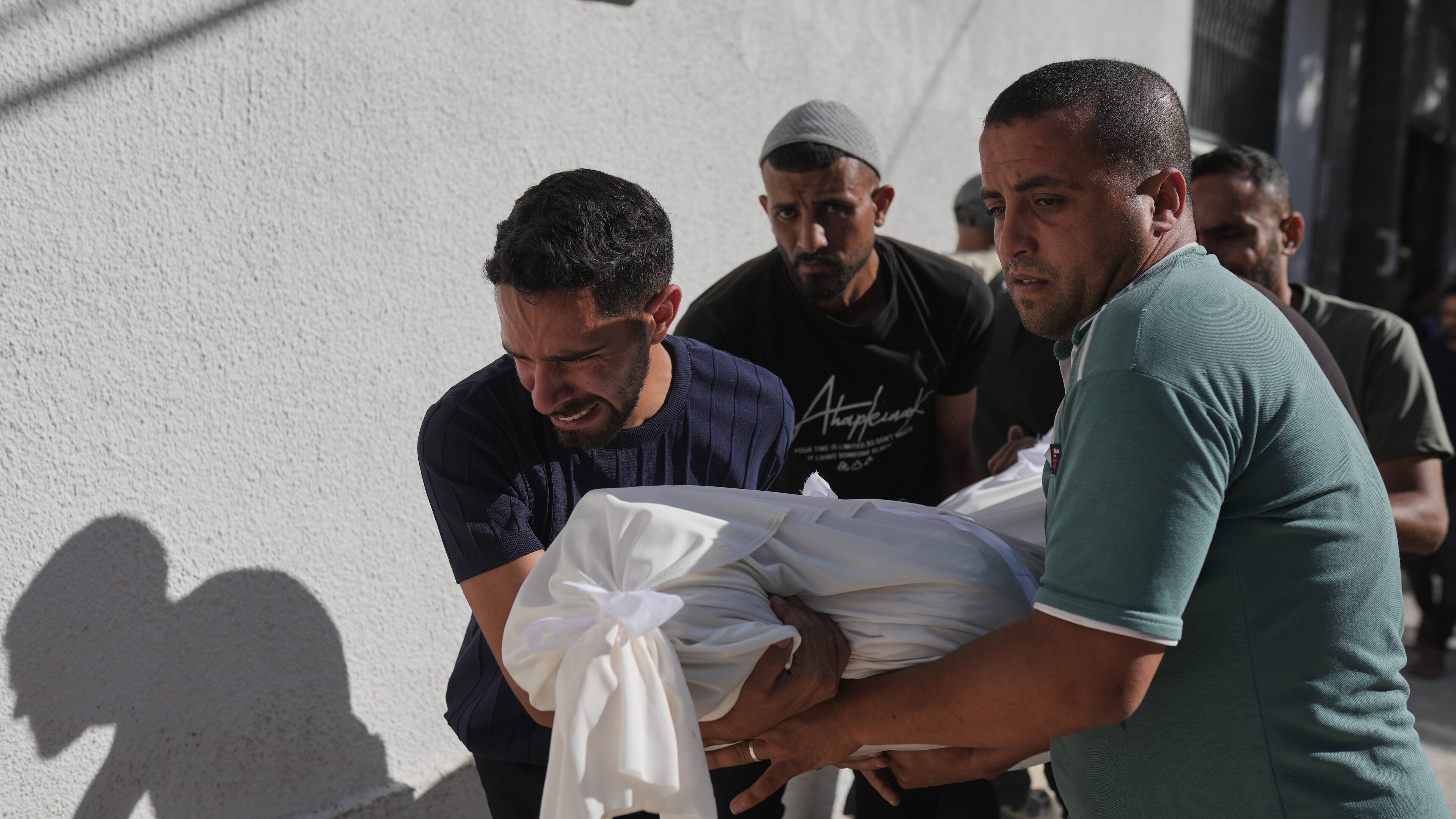 Relatives carry the body of Shadi Abu Sweilem, who was killed in an Israeli airstrike, during his funeral at Al-Shifa Hospital in Gaza City Sunday, June 14, 2026. (AP Photo/Jehad Alshrafi)